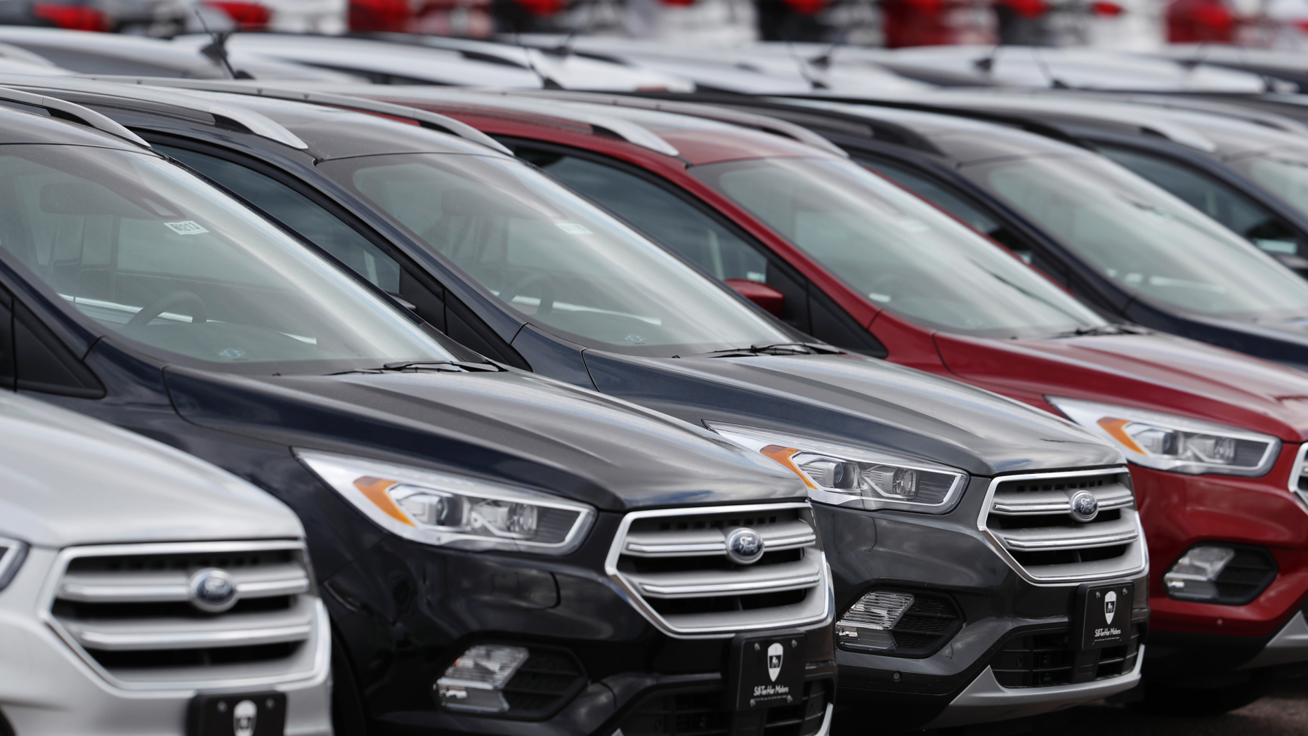 FILE- In this Feb. 17, 2019, file photo rows of unsold 2019 Escape sports-utility vehicles sit in long rows at a Ford dealership in Broomfield, Colo. On Wednesday, May 15, the Commerce Department releases U.S. retail sales data for April. (AP Photo/David Zalubowski, File)