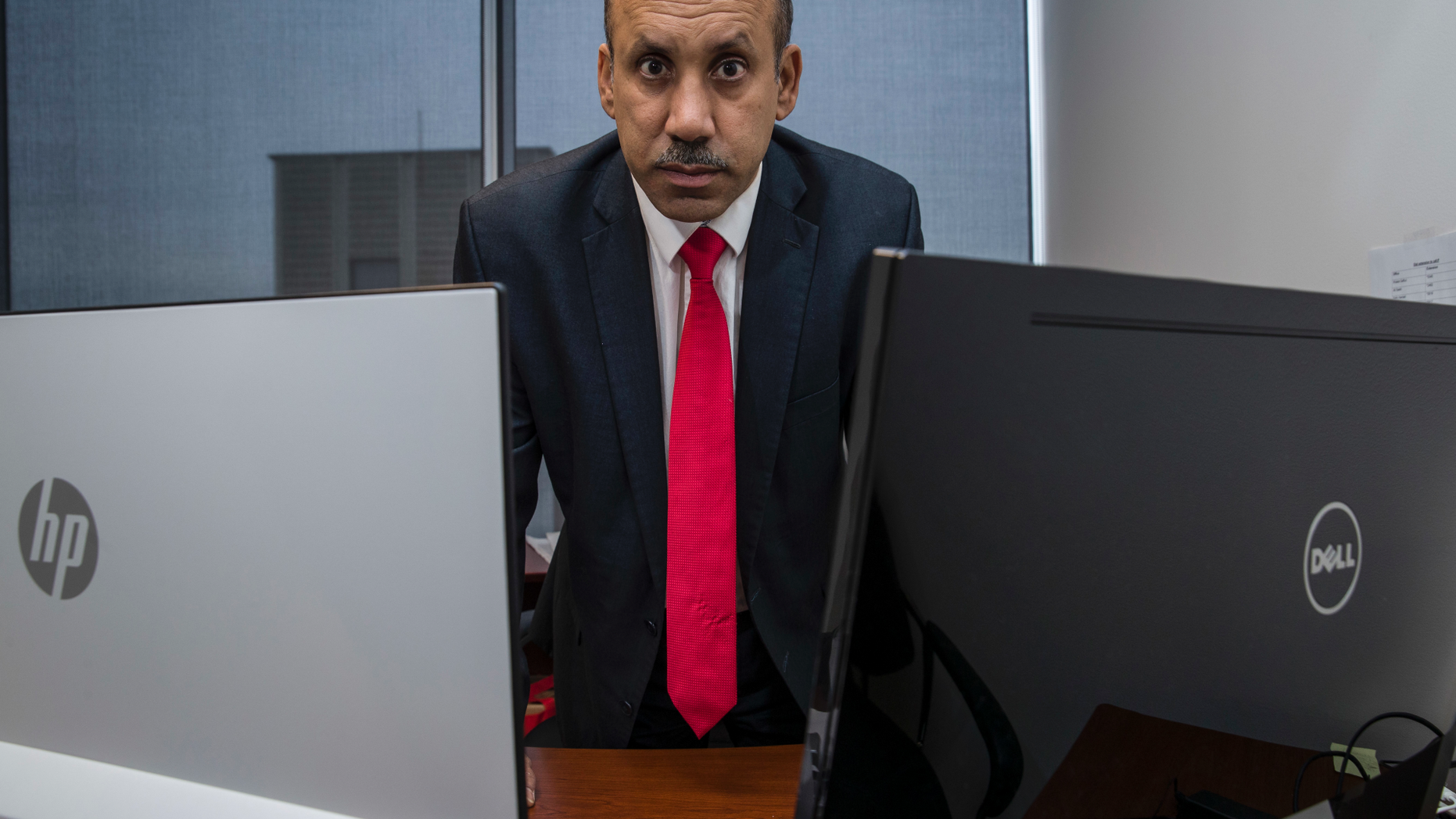 FILE - In this Oct. 26, 2018, file photo Ali AlAhmed poses for a photograph in his office in Washington. Citizen Lab says a fake Twitter account unmasked by The Associated Press was but one piece of a vast years-old and multi-lingual campaign aimed at seeding anti-Saudi, anti-Israel and anti-American stories across the internet. The Associated Press was on the verge of publishing a story about how AlAhmed, who is based in the Washington area, had been targeted by hackers posing as a female journalist. (AP Photo/Alex Brandon, File)