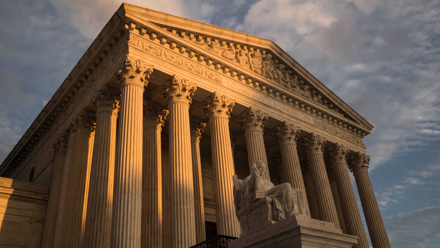 FILE - In this Oct. 10, 2017, file photo, the Supreme Court in Washington, at sunset. The Justice Department’s ability to charge minors for supporting terrorist groups has been hampered by a 2018 Supreme Court decision, forcing prosecutors to hand off at least one such case to local authorities in a state without anti-terrorism laws. (AP Photo/J. Scott Applewhite, File)