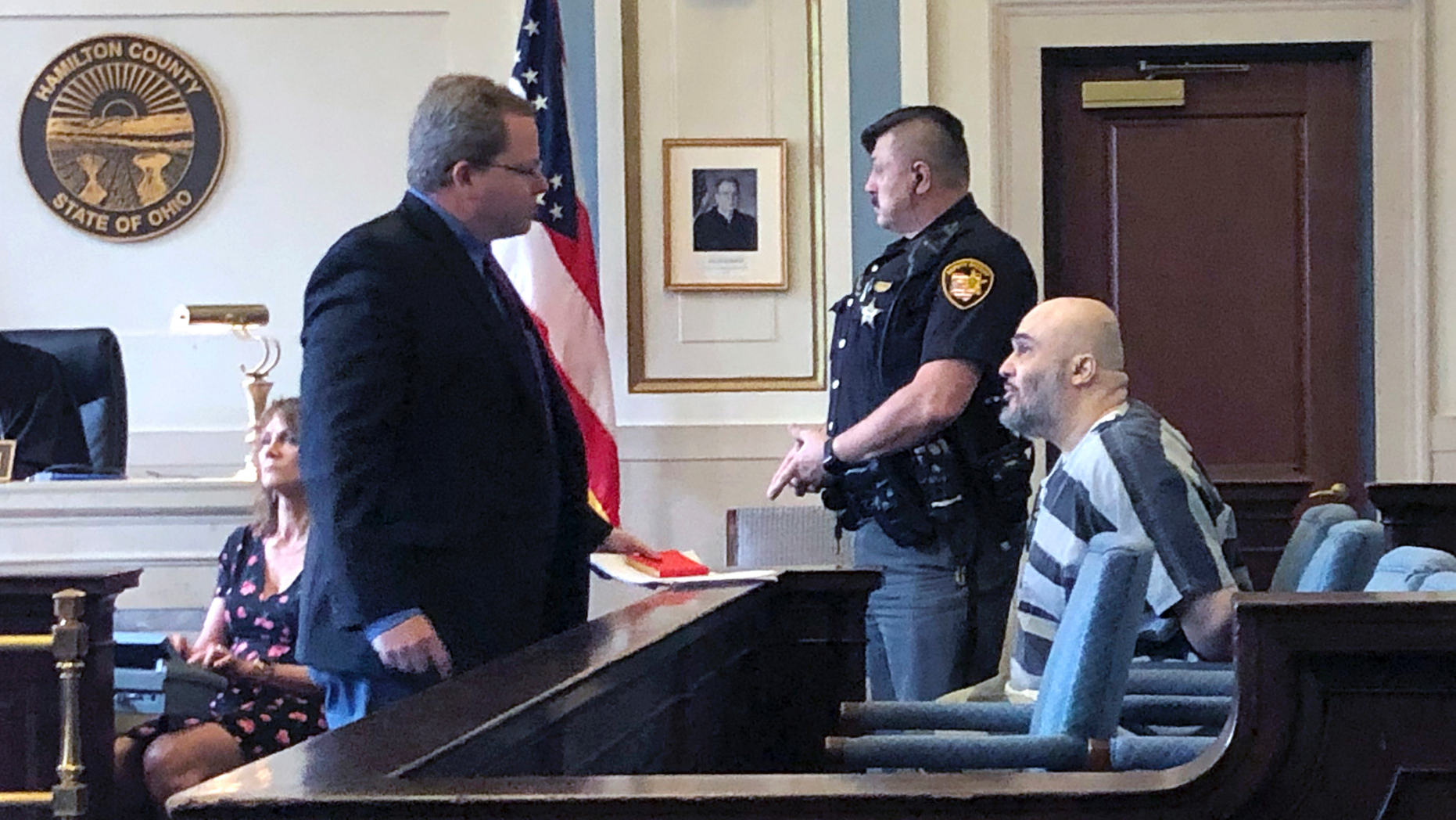 Ahmad Fawzi Issa, right, sits in Hamilton County Court Thursday May 30, 2019 in Cincinnati. Issa, 49, who was sentenced to death in 1998, appeared before a county judge after a federal appeals court threw out his conviction. Issa pleaded not guilty to aggravated murder in Hamilton County and will remain jailed without bond pending resolution of his case. Heis now off Ohio's death row after more than 20 years because his conviction was tossed is back in court and likely facing deportation to his native Jordan. (AP Photo/Dan Sewell)