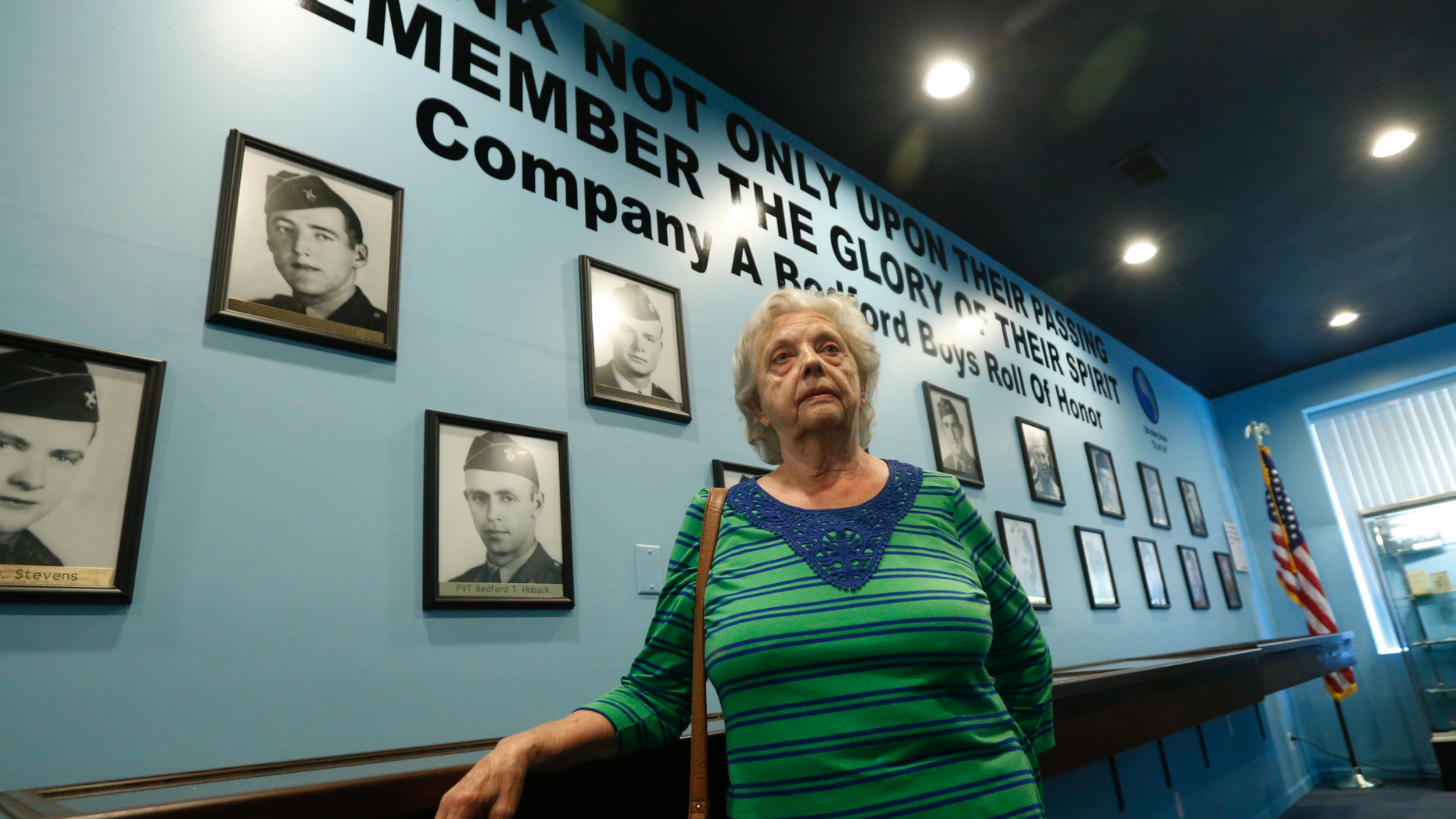 In this May 6, 2019, photo, Marguerite Cottrell, sister of John Reynolds, speaks during an interview at a recently opened tribute center for the Bedford Boys in Bedford, Va. Reynolds, had been killed in the D-Day invasion of Normandy on the coast of France. The 75th anniversary of the D-Day invasion of Normandy has a solemn significance for the small town of Bedford, who lost 20 local men. (AP Photo/Steve Helber)
