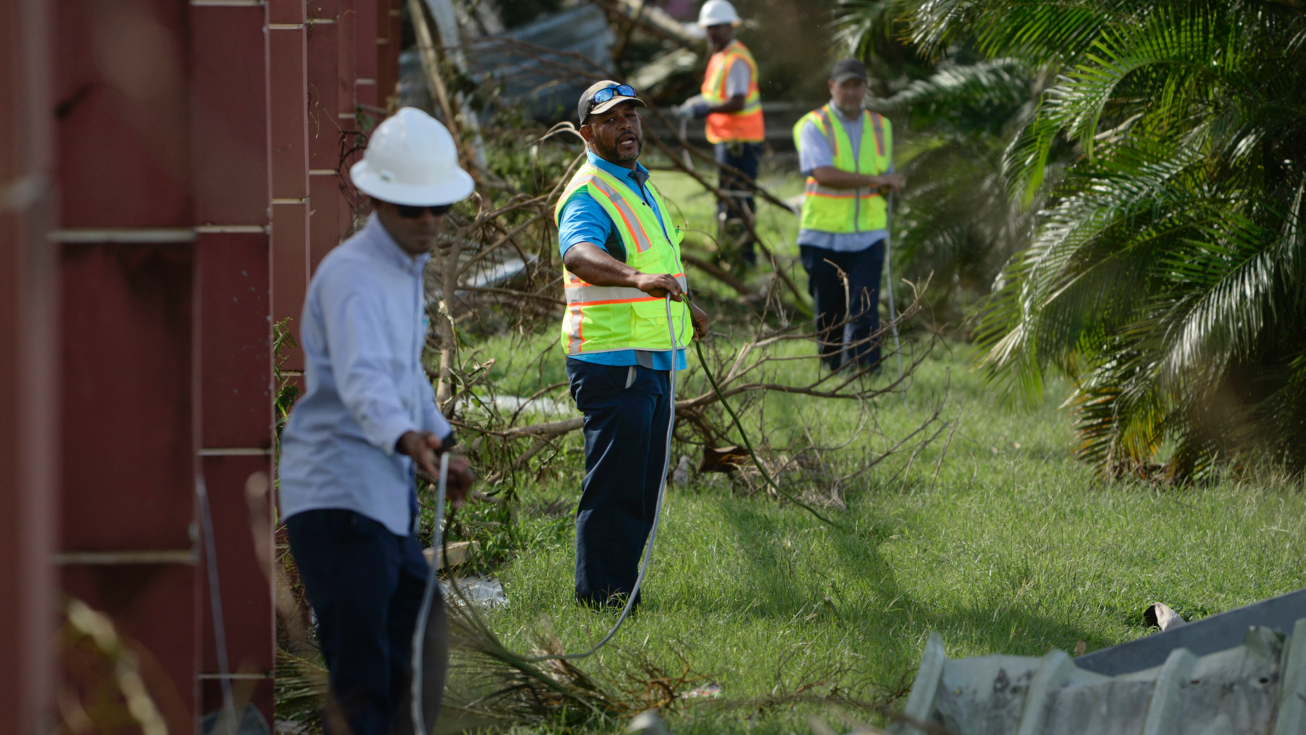 FILE - In this Sept. 23, 2017 file photo, personnel from Liberty Cable work to restore fiber optic lines on the third day after the impact of Maria, a Category 5 hurricane that crossed the island, in Carolina, Puerto Rico. A report issued Tuesday, May 13, 019, by the group Free Press, a consumer activist group, is calling on the U.S. government to investigate the collapse of communications in Puerto Rico after Hurricane Maria to avoid a repeat of the situation as the island prepares for another storm season. (AP Photo/Carlos Giusti, File)
