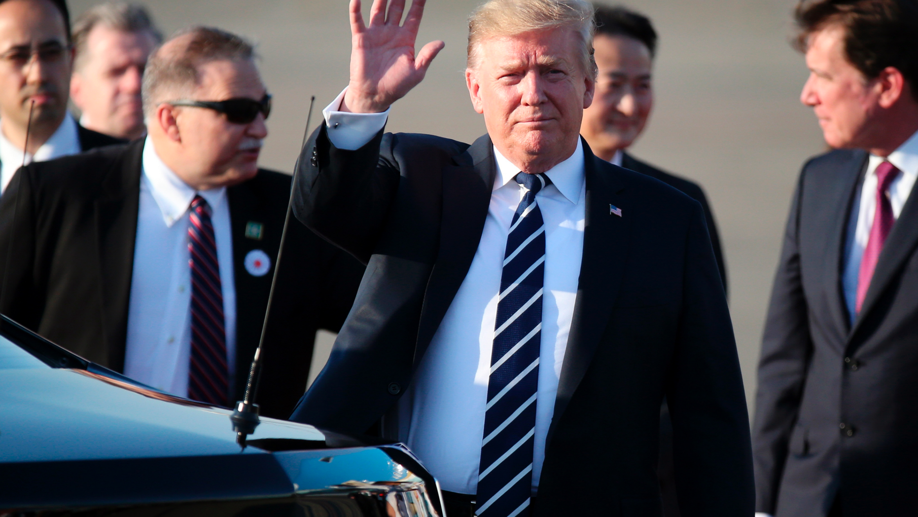 U.S. President Donald Trump waves as he arrives at the Haneda International Airport Saturday, May 25, 2019, in Tokyo. (AP Photo/Koji Sasahara, Pool)