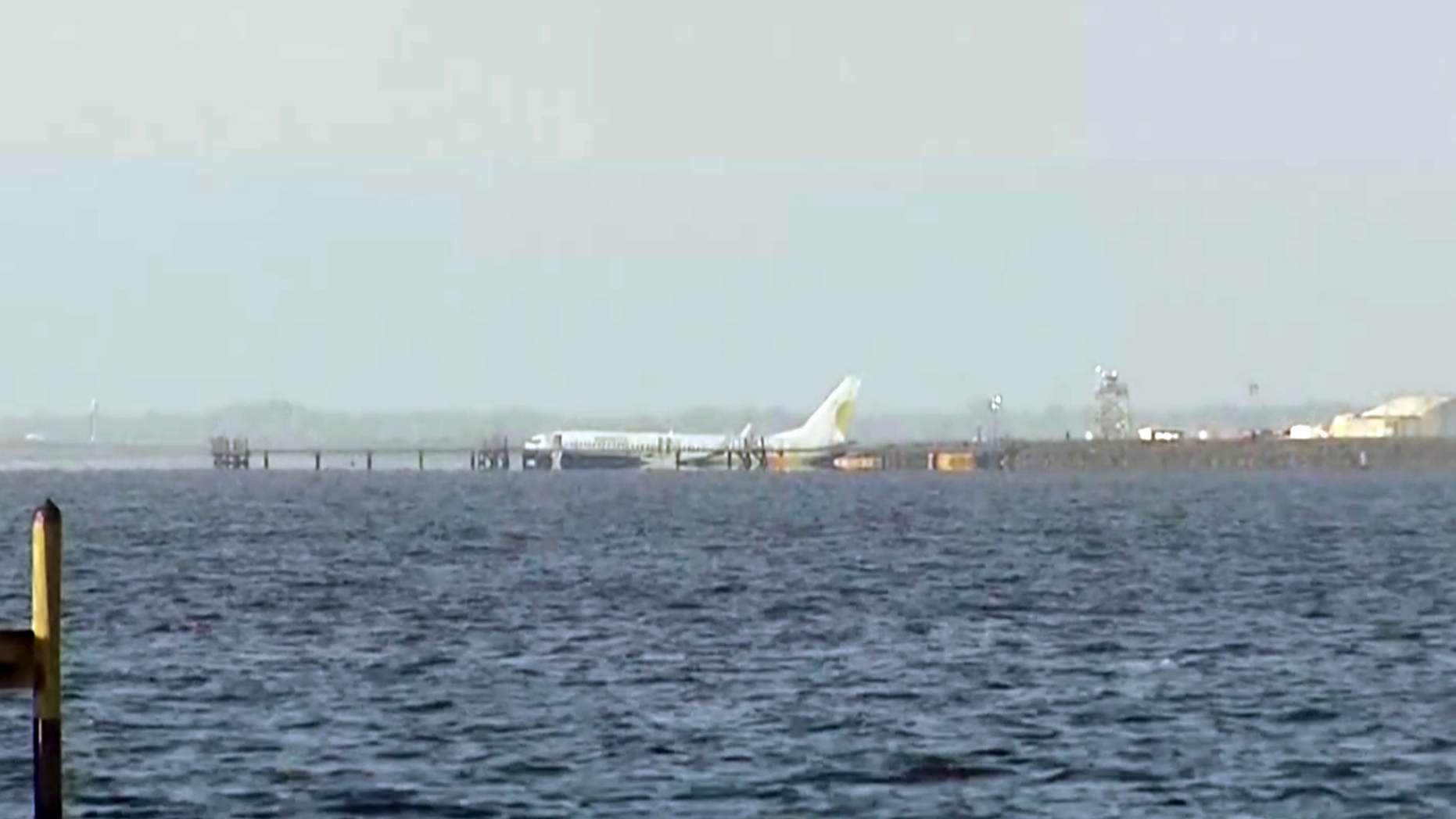 A charter plane carrying 143 people and traveling from Cuba to north Florida sits in a river at the end of a runway, Saturday, May 4, 2019 in Jacksonville, Fla. The Boeing 737 arriving at Naval Air Station Jacksonville from Naval Station Guantanamo Bay, Cuba, with 136 passengers and seven aircrew slid off the runway Friday night into the St. Johns River, a NAS Jacksonville news release said. (AP Photo/APTN)