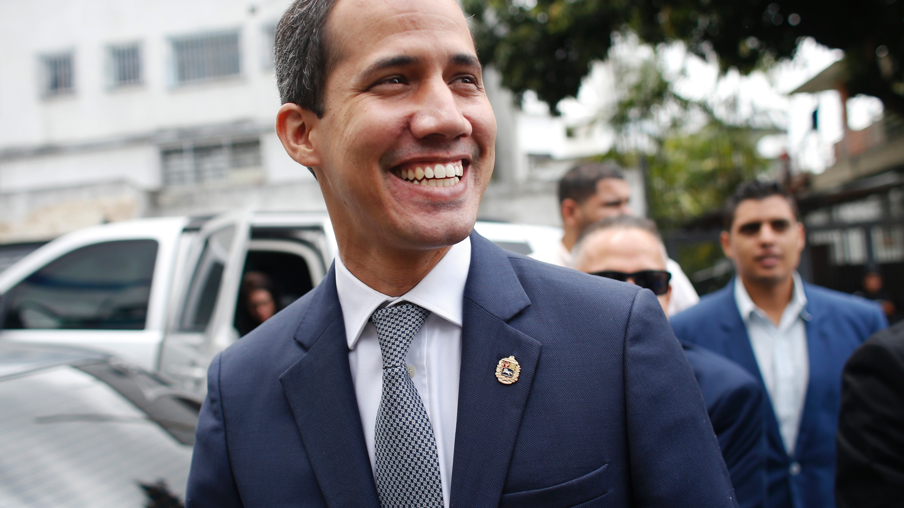Opposition leader Juan Guaidó smiles at supporters as he arrives for a press conference in Caracas, Venezuela, Friday, May 3, 2019. In the fourth month of their standoff, President Nicolás Maduro and Juan Guaidó are unable to deliver a knock-out blow as Venezuela spirals deeper into neglect, isolation and desperation. (AP Photo/Ariana Cubillos)