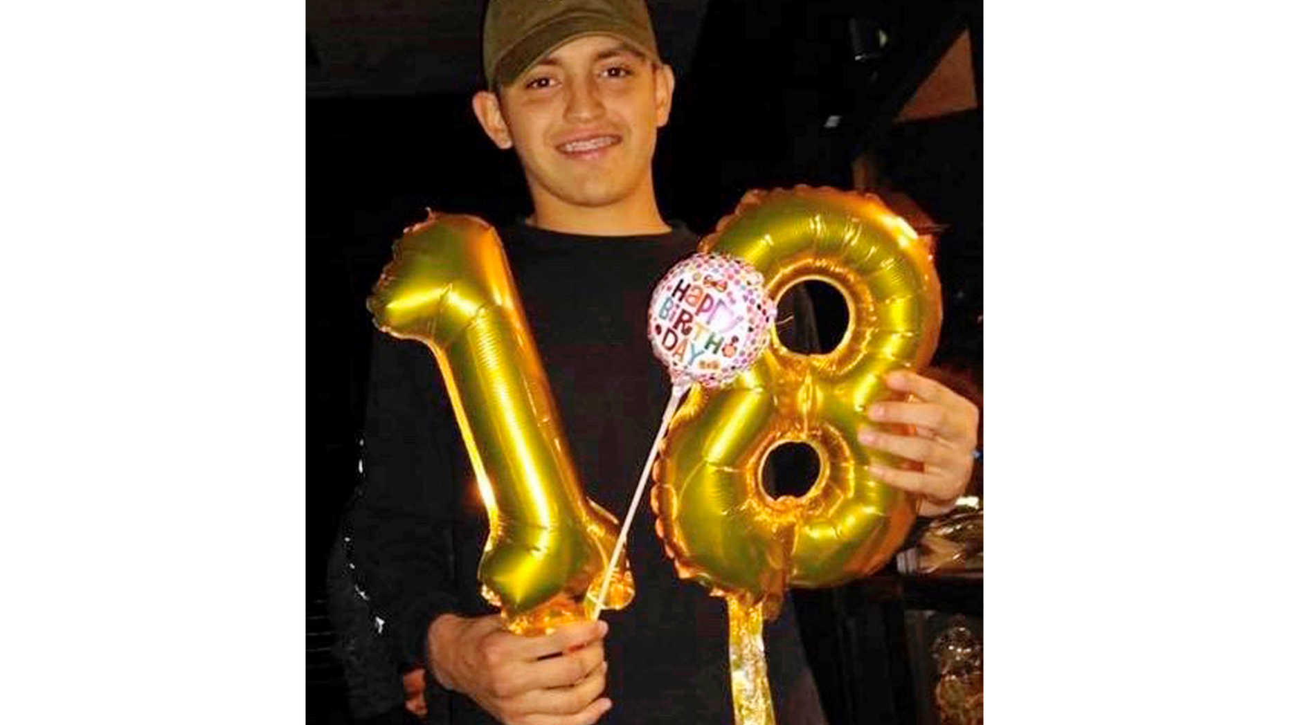 In this December 2018 photo provided by Lorena Rodriguez, Thomas Torres holds up the numbers 1 and 8 to mark his 18th birthday in Tucson, Ariz. Torres, a high school football player who has been in the U.S. since he was a toddler, was in custody for possible deportation to his native Mexico, prompting a protest Monday, May 6, 2019, by classmates outside an Arizona sheriff's office. (Lorena Rodriguez via AP)
