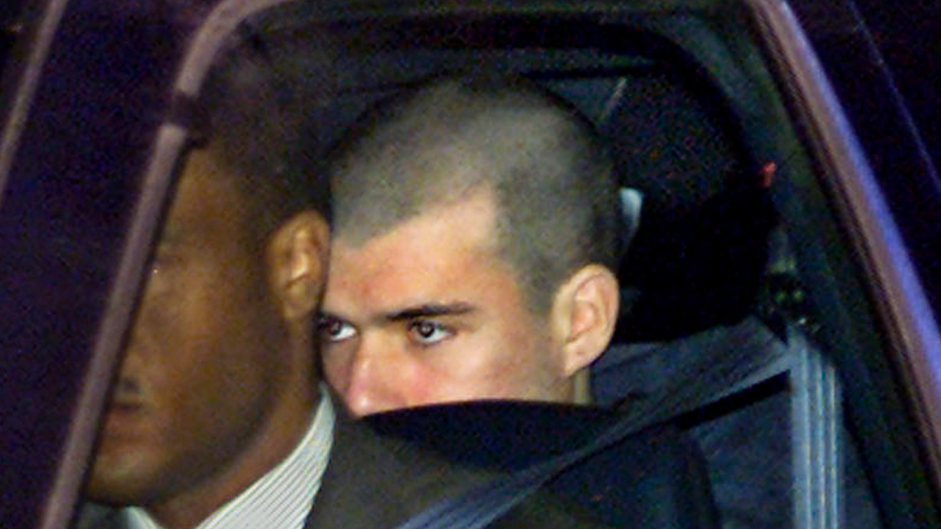 FILE - In this Jan. 24, 2002 file photo, John Walker Lindh, far right, leaves the Alexandria Detention Center in Alexandria, Va., before dawn, on the way to his first appearance in a nearby federal court. Lindh, the young Californian who became known as the American Taliban after he was captured by U.S. forces in the invasion of Afghanistan in late 2001, is set to go free Thursday, May 23, 2019, after nearly two decades in prison. (AP Photo/J. Scott Applewhite, File)