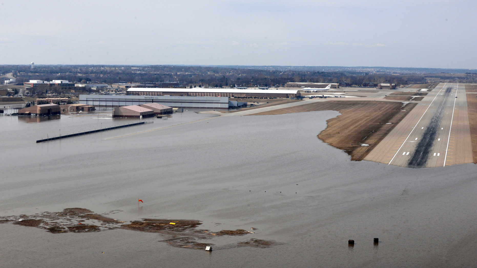 FILE - This March 17, 2019, file photo provided by the U.S. Air Force shows an aerial view of Offutt Air Force Base and the surrounding areas affected by floodwaters in Nebraska. The Air Force is raising its cost estimate to $420 million to repair and replace structures damaged at the Nebraska base following severe flooding that inundated buildings with water. (Tech. Sgt. Rachelle Blake/U.S. Air Force via AP, File)