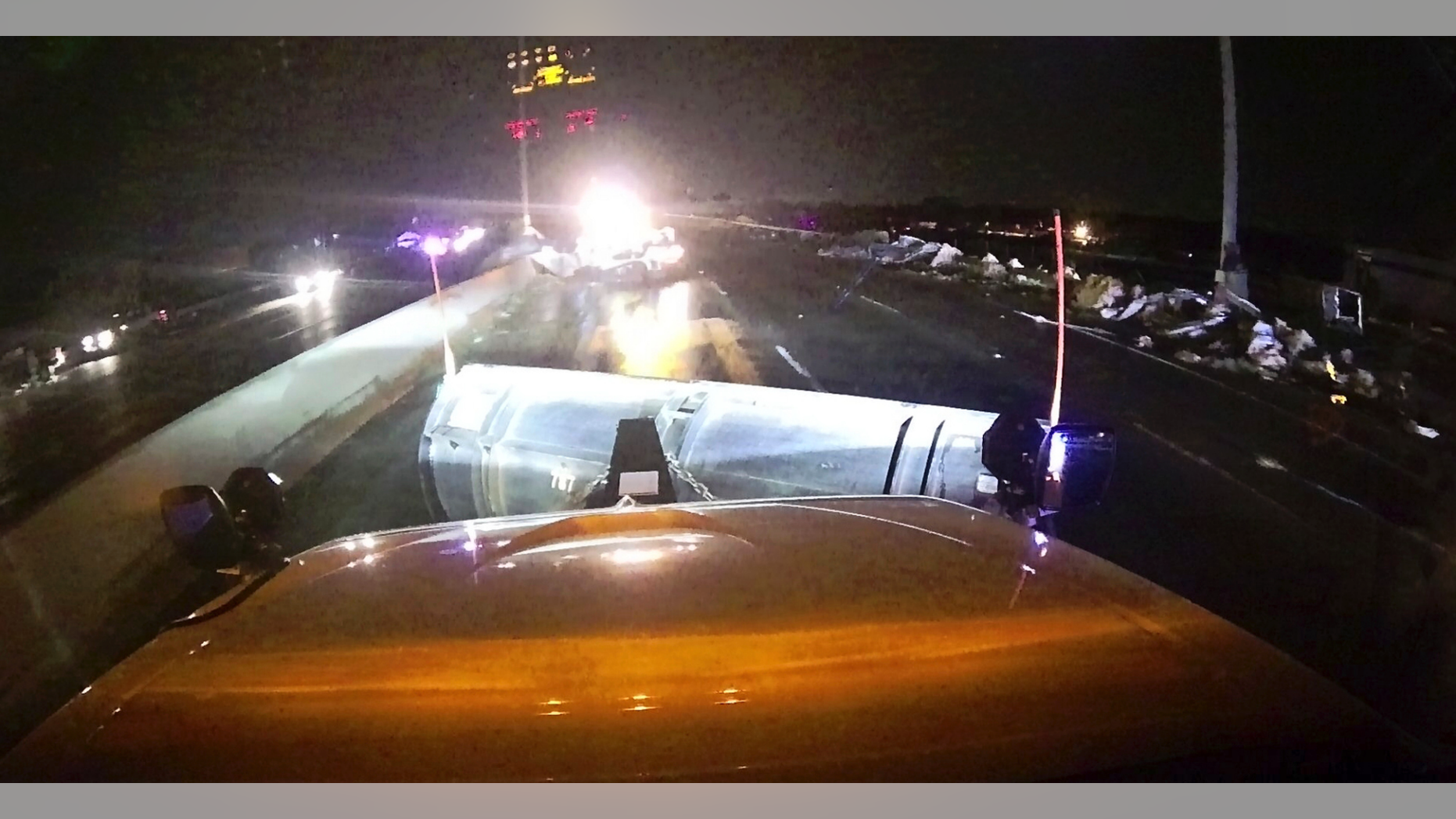 This image provided and posted by the Ohio Department of Transportation, early Tuesday, May 28, 2019, shows a view from one of the department's trucks as crews on Interstate 75 north of Dayton, Ohio, work to clean debris from the highway after a suspected tornado hit the area. (Ohio Department of Transportation via AP)