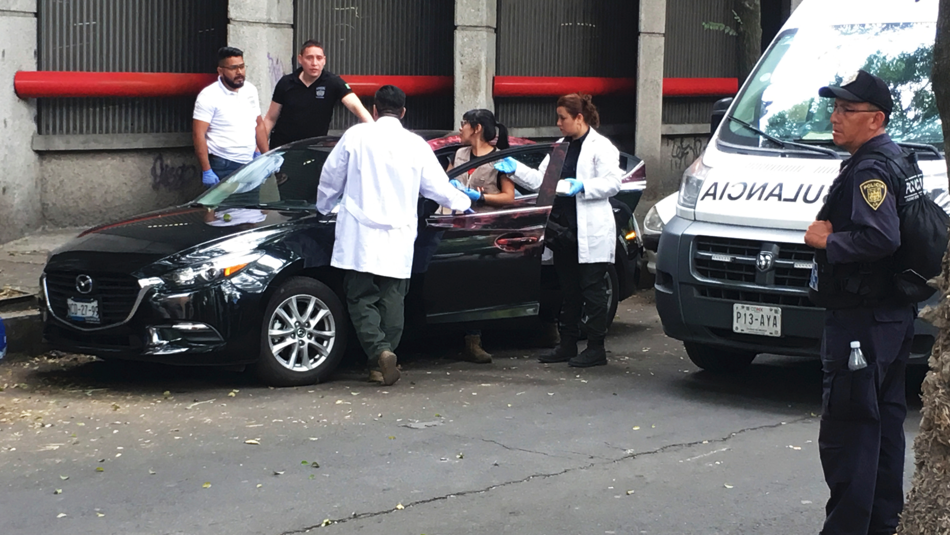 Forensic investigators examine a vehicle after the bodyguard of prominent Mexican journalist Héctor de Mauleón repelled an assault, in Mexico City, Monday, May 6, 2019. One man was killed in the attack and It was not immediately clear if de Mauleón was targeted or if it was an attempted carjacking. (AP Photo/Peter Orsi)
