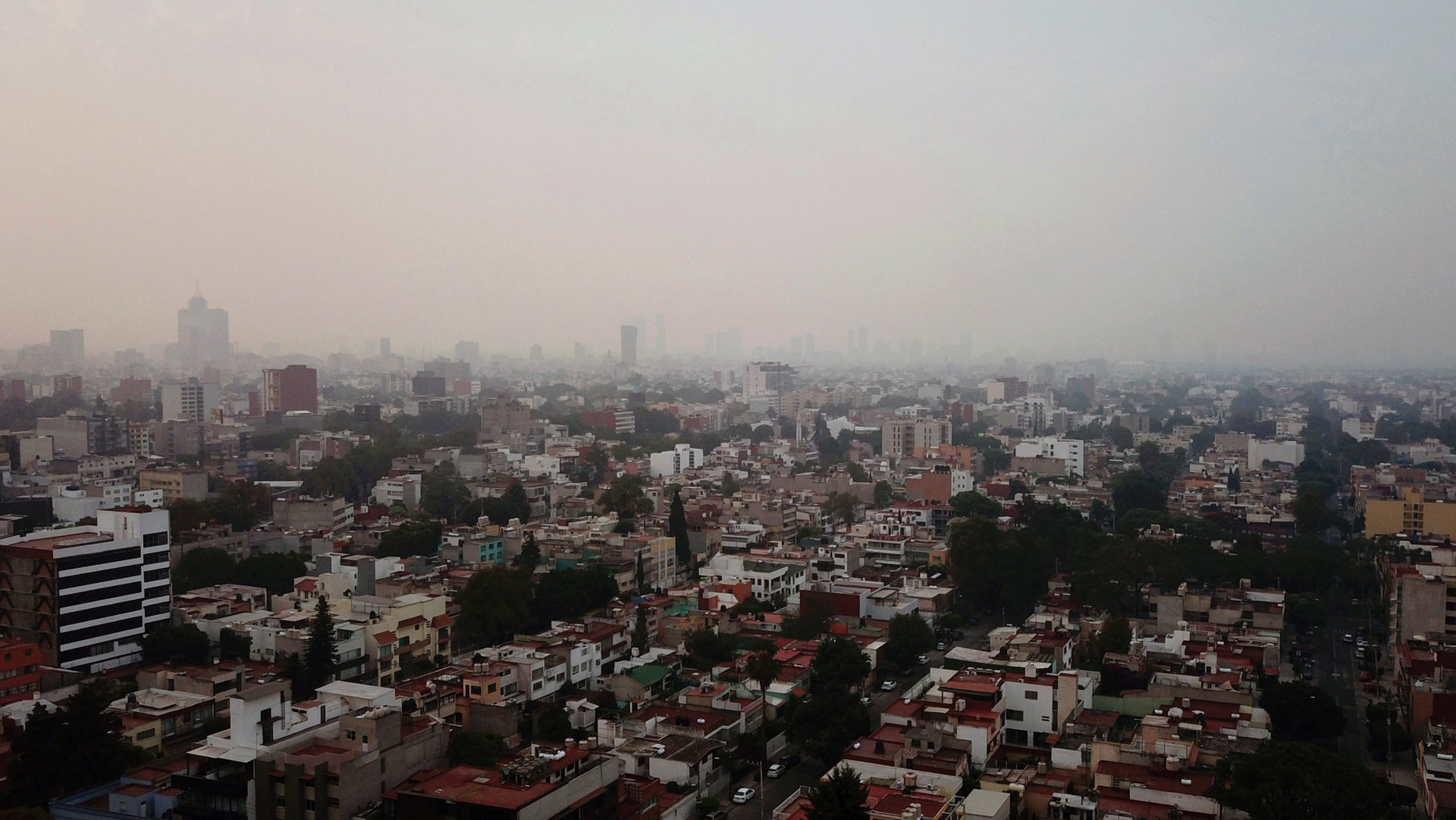 Smoke covers Mexico City, Sunday, May 12, 2019. Mexico City has warned residents to remain indoors as forest and brush fires carpet the metropolis in smoke. (AP Photo/Christian Palma)