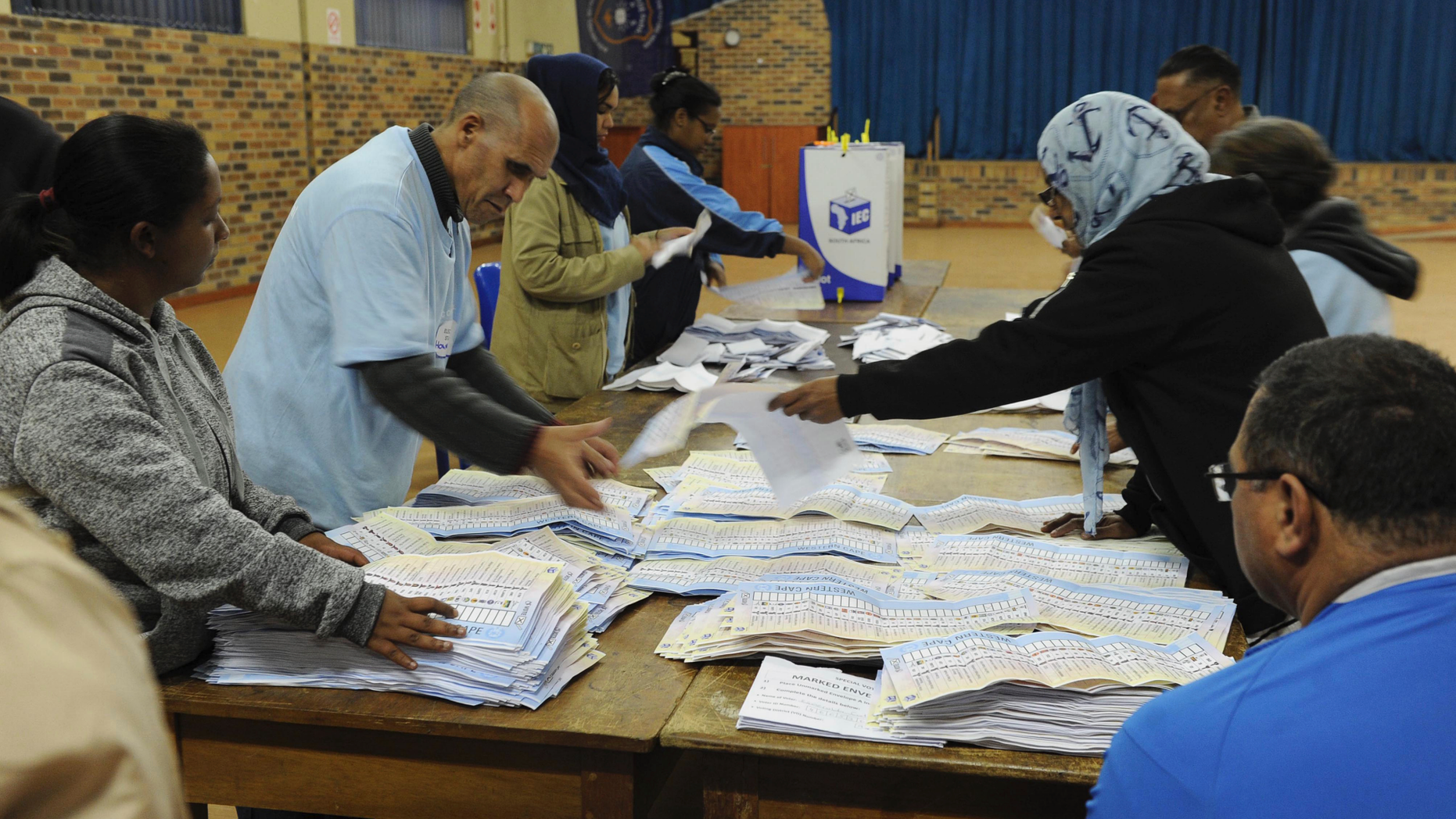 In this photo taken Wednesday, May 8, 2019, vote counting begins at a polling station in Cape Town, South Africa. Vote counting continued Thursday May 9, 2019 after South Africans voted Wednesday in a national election that pits President Cyril Ramaphosa's ruling African National Congress against top opposition parties Democratic Alliance and Economic Freedom Fighters, 25 years after the end of apartheid. (AP Photo/Nasief Manie)