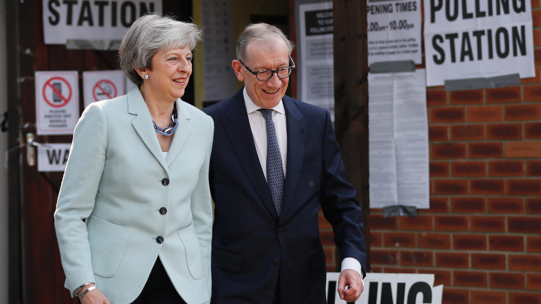Britain's Prime Minister Theresa May and her husband Philip leave a polling station after voting in the European Elections in Sonning, England, Thursday, May 23, 2019.(AP Photo/Frank Augstein)
