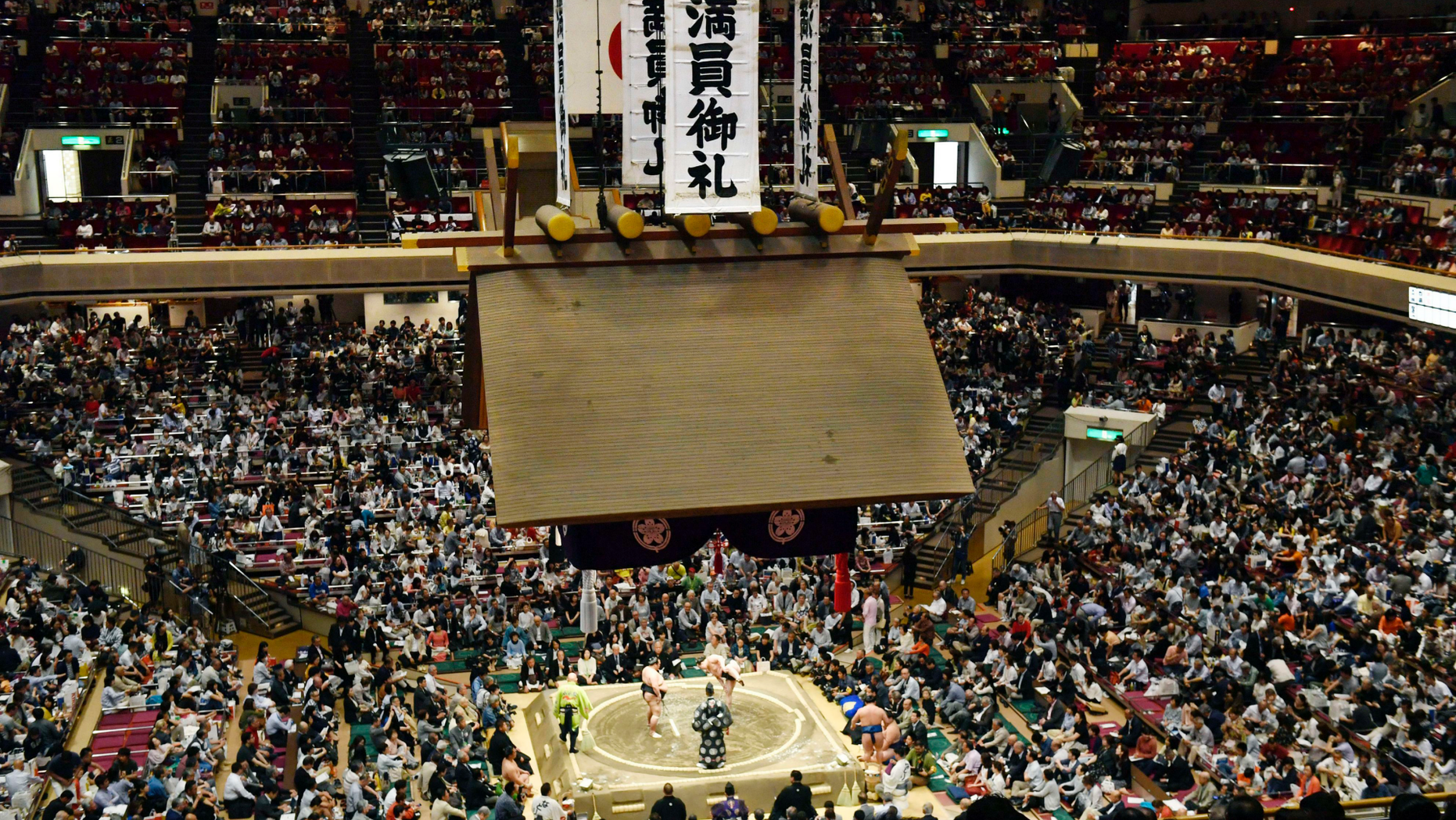 In this May 12, 2019, photo, banners thanking for a sellout crowd are displayed on the first day of Summer Grand Sumo Tournament in Tokyo. Plans for U.S. President Donald Trump to check out the ancient Japanese sport of sumo wrestling during a state visit are raising security issues for organizers. (Yoshitaka Sugawara/Kyodo News via AP)
