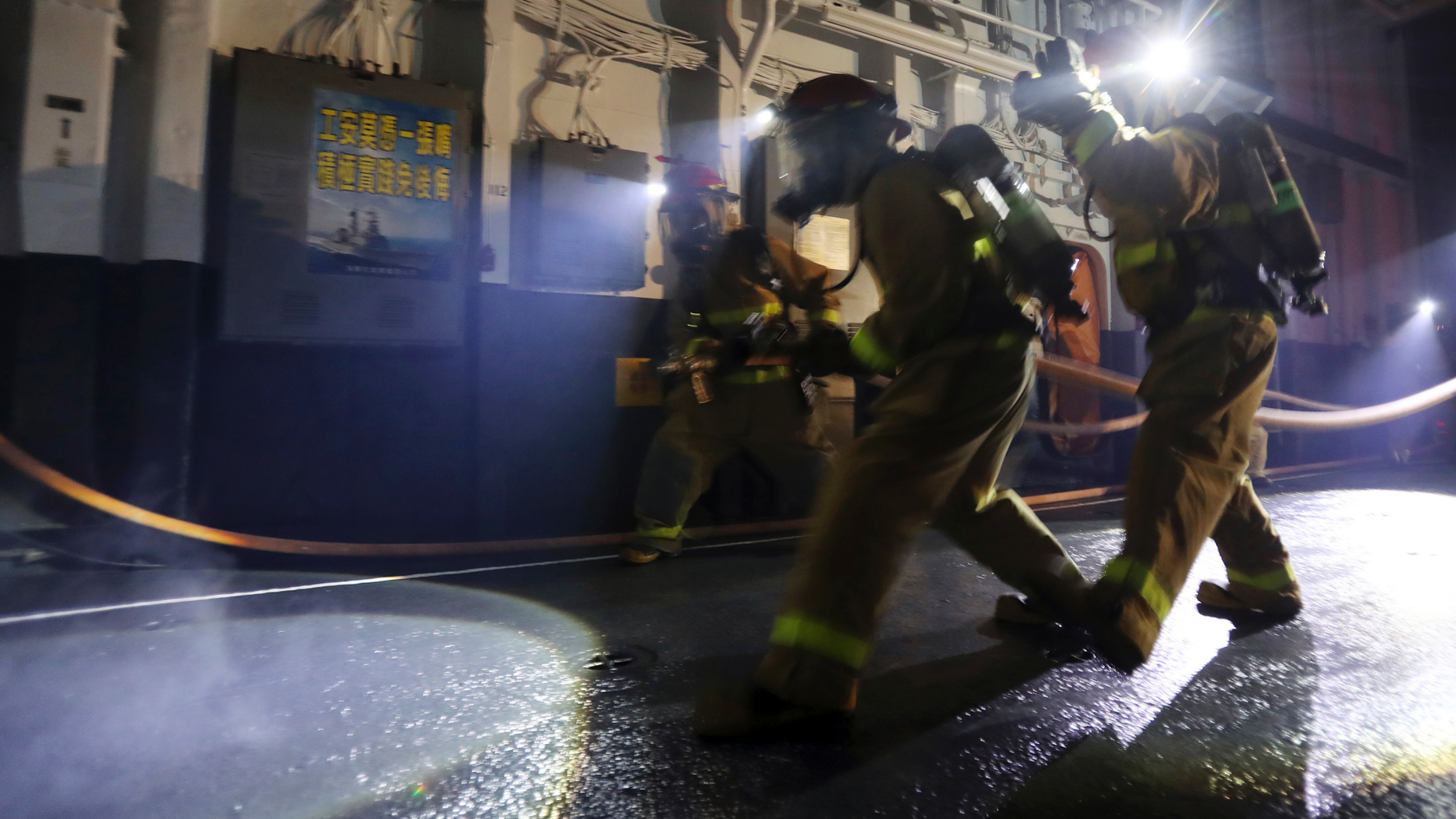 I this photo taken on Wednesday, May 21, 2019, Taiwan navy personnel simulate a fire drill inside the Knox-class frigate during an exercise in the Suao port in Yilan County, eastern Taiwan. (AP Photo/Chiang Ying-ying)