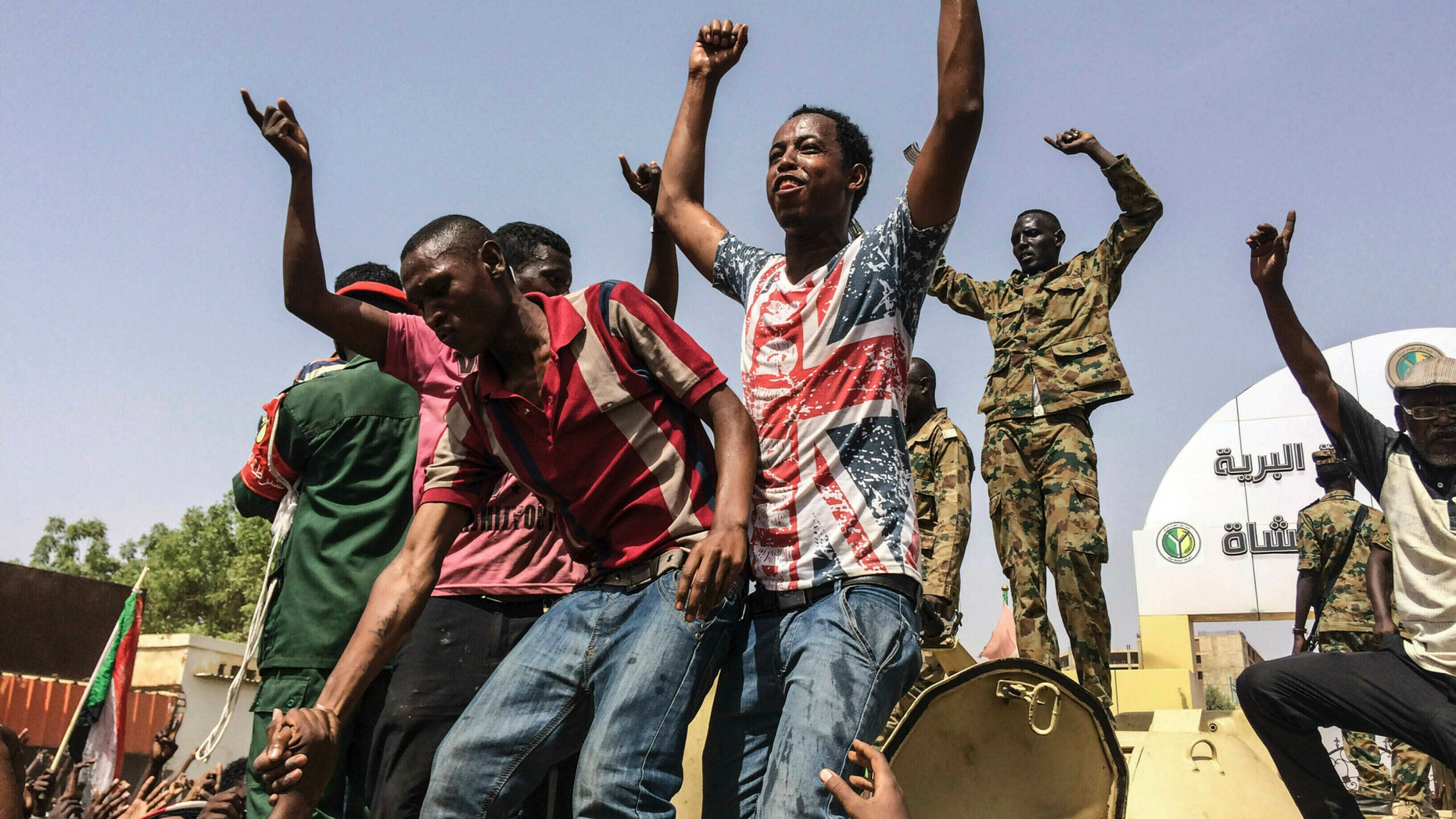 FILE - In this April 11, 2019 file photo, Sudanese celebrate after officials said the military had forced longtime autocratic President Omar al-Bashir to step down after 30 years in power in Khartoum, Sudan. As the uprising against Sudanese President Omar al-Bashir gained strength, Egypt, the United Arab Emirates and Saudi Arabia began reaching out to the military through secret channels to encourage his removal from power. They had long viewed al-Bashir as a problem because of his close ties to Islamists. (AP Photo, File)
