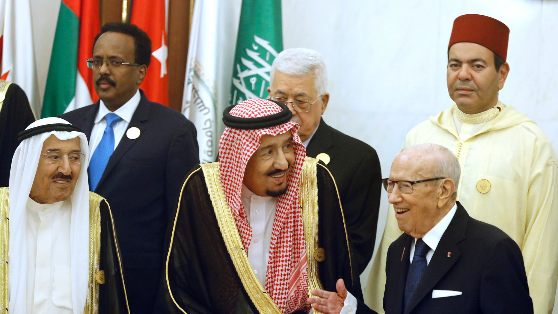 Kuwait's Emir Sheikh Sabah al-Ahmad al-Jaber al-Sabah, left, and Saudi Arabia's King Salman, center, listen to Tunisian President Beji Caid Essebsi, right, during a group photo session ahead of an emergency Arab summit in Mecca, Saudi Arabia, Thursday, May 30, 2019. King Salman opened an emergency summit of Gulf Arab leaders in the holy city of Mecca on Thursday with a call for the international community to use all means to confront Iran, but he also said the kingdom extends its hand for peace. (AP Photo/Amr Nabil)