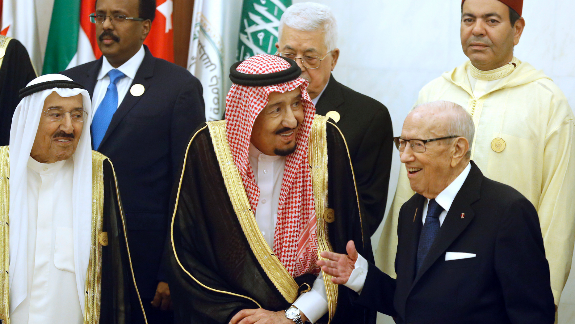 Kuwait's Emir Sheikh Sabah al-Ahmad al-Jaber al-Sabah, left, and Saudi Arabia's King Salman, center, listen to Tunisian President Beji Caid Essebsi, right, during a group photo session ahead of an emergency Arab summit in Mecca, Saudi Arabia, Thursday, May 30, 2019. King Salman opened an emergency summit of Gulf Arab leaders in the holy city of Mecca on Thursday with a call for the international community to use all means to confront Iran, but he also said the kingdom extends its hand for peace. (AP Photo/Amr Nabil)