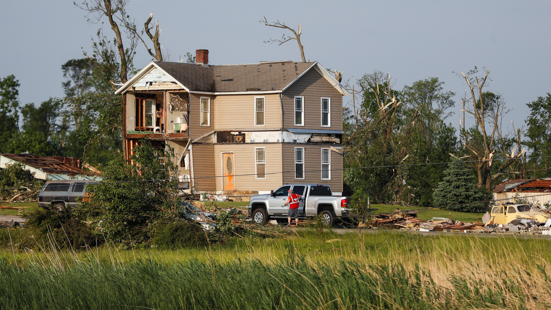 Homes stand damaged after a tornado passed through the area the previous evening, Tuesday, May 28, 2019, in Brookville, Ohio. (AP Photo/John Minchillo)