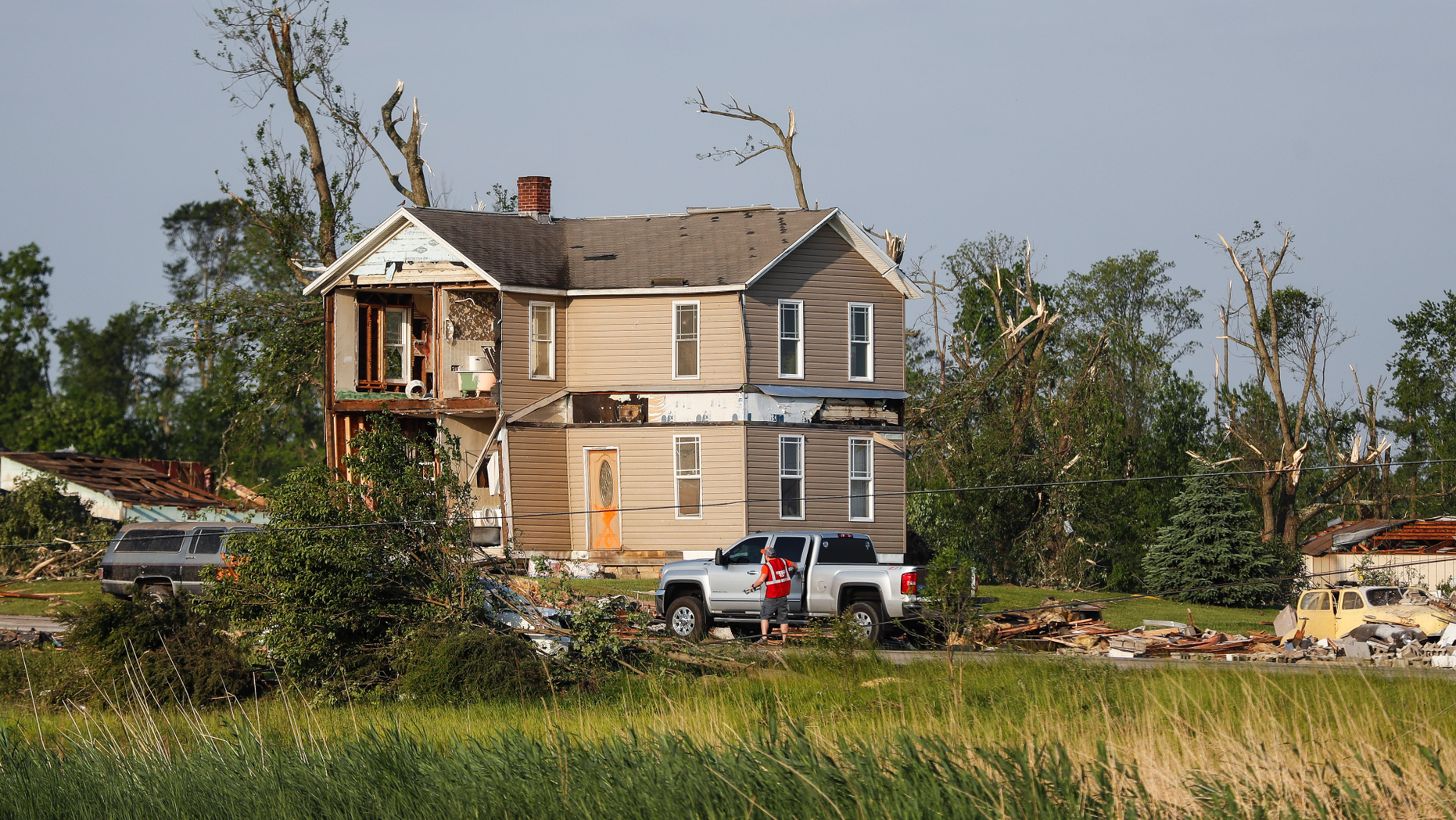 Homes stand damaged after a tornado passed through the area the previous evening, Tuesday, May 28, 2019, in Brookville, Ohio. (AP Photo/John Minchillo)