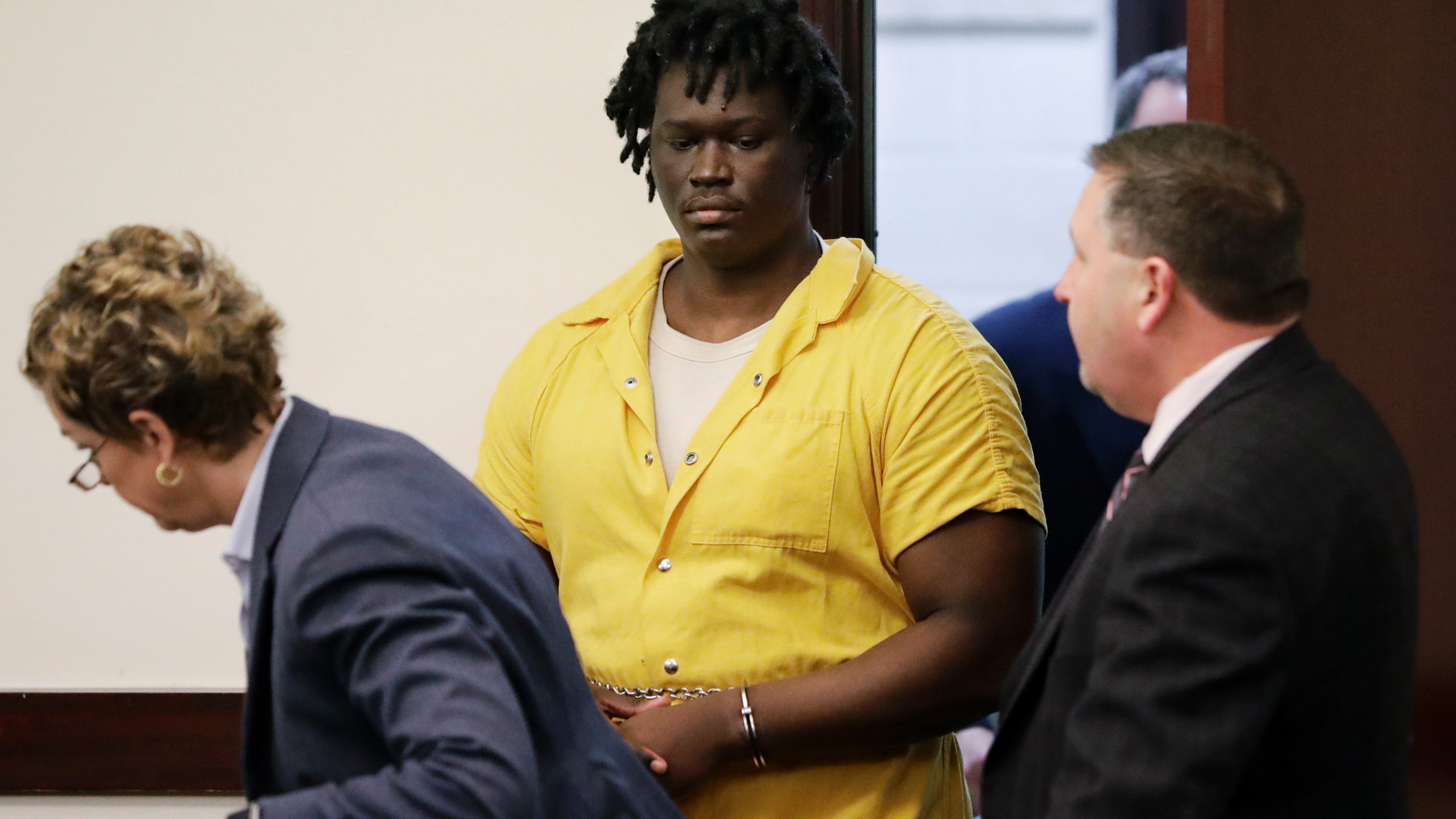 FILE - In this Feb. 20, 2019, file photo, Emanuel Kidega Samson, center, enters the courtroom for a hearing in Nashville, Tenn. Prosecutors have said they're seeking life without parole for 27-year-old Samson, accused of fatally shooting a woman and wounding several people at a Nashville church. His trial is slated to begin Monday, May 20. (AP Photo/Mark Humphrey, File)