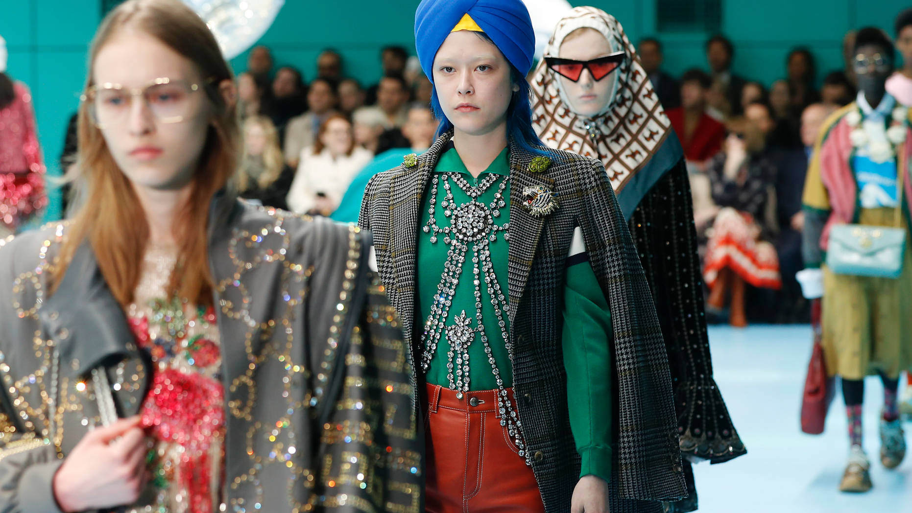 FILE - In this Feb. 21, 2018 file photo, models display items from Gucci's women's Fall/Winter 2018-2019 collection, presented during the Milan Fashion Week, in Milan, Italy. The top civil rights organization for Sikhs in the United States says Nordstrom has apologized to the community for selling an $800 turban they found offensive, but they are still waiting to hear from the Gucci brand that designed it, Saturday, May 18, 2019. (AP Photo/Antonio Calanni, File)