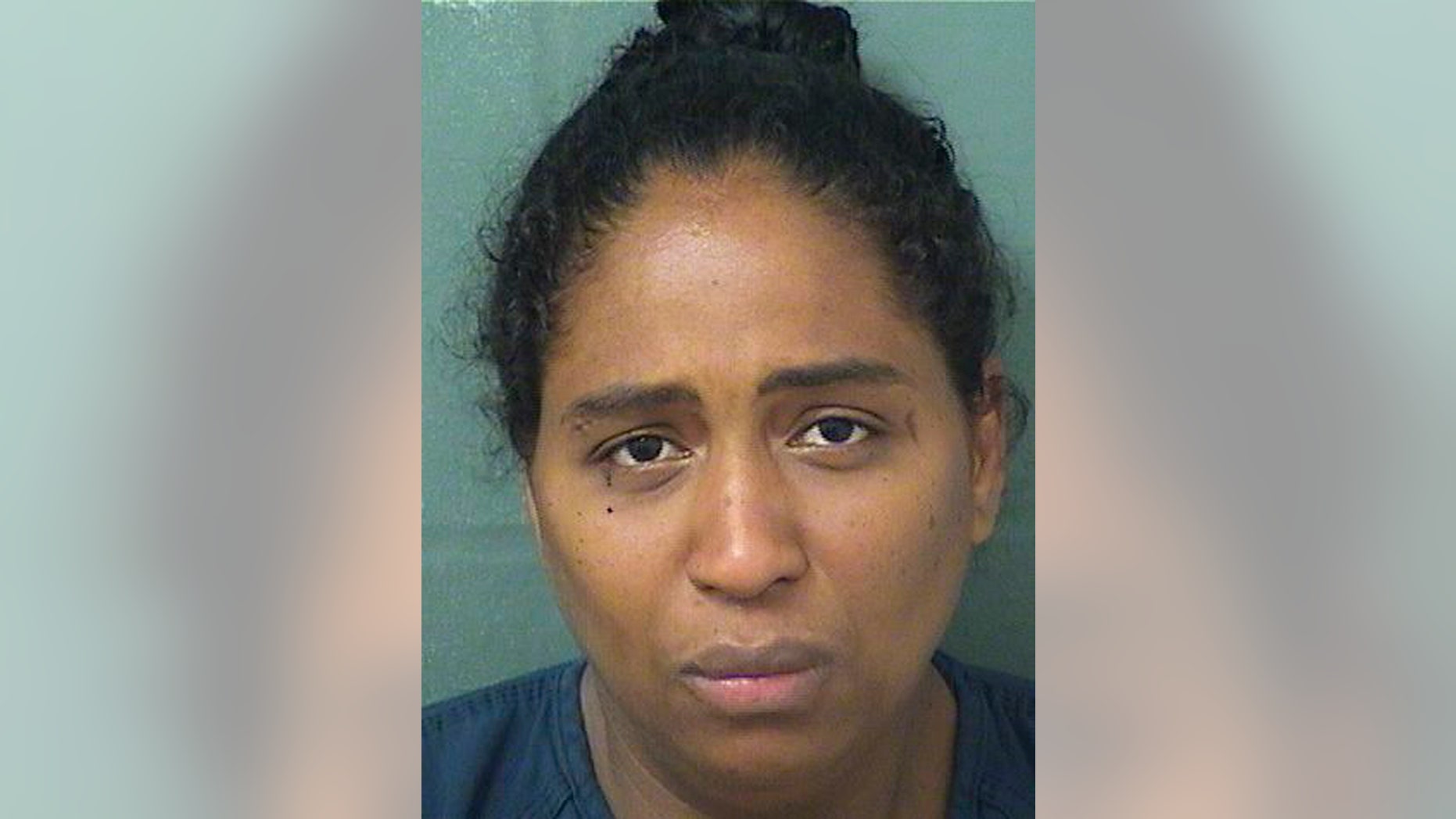 This May 9, 2019 photo made available by the Palm Beach County Sherif's Office shows Rafaelle Sousa under arrest. Sousa is charged with attempted murder and child abuse after she delivered a baby girl, put her in a plastic bag and tossed her into a dumpster. The baby was found alive. (Palm Beach County Sheriff's Office via AP)