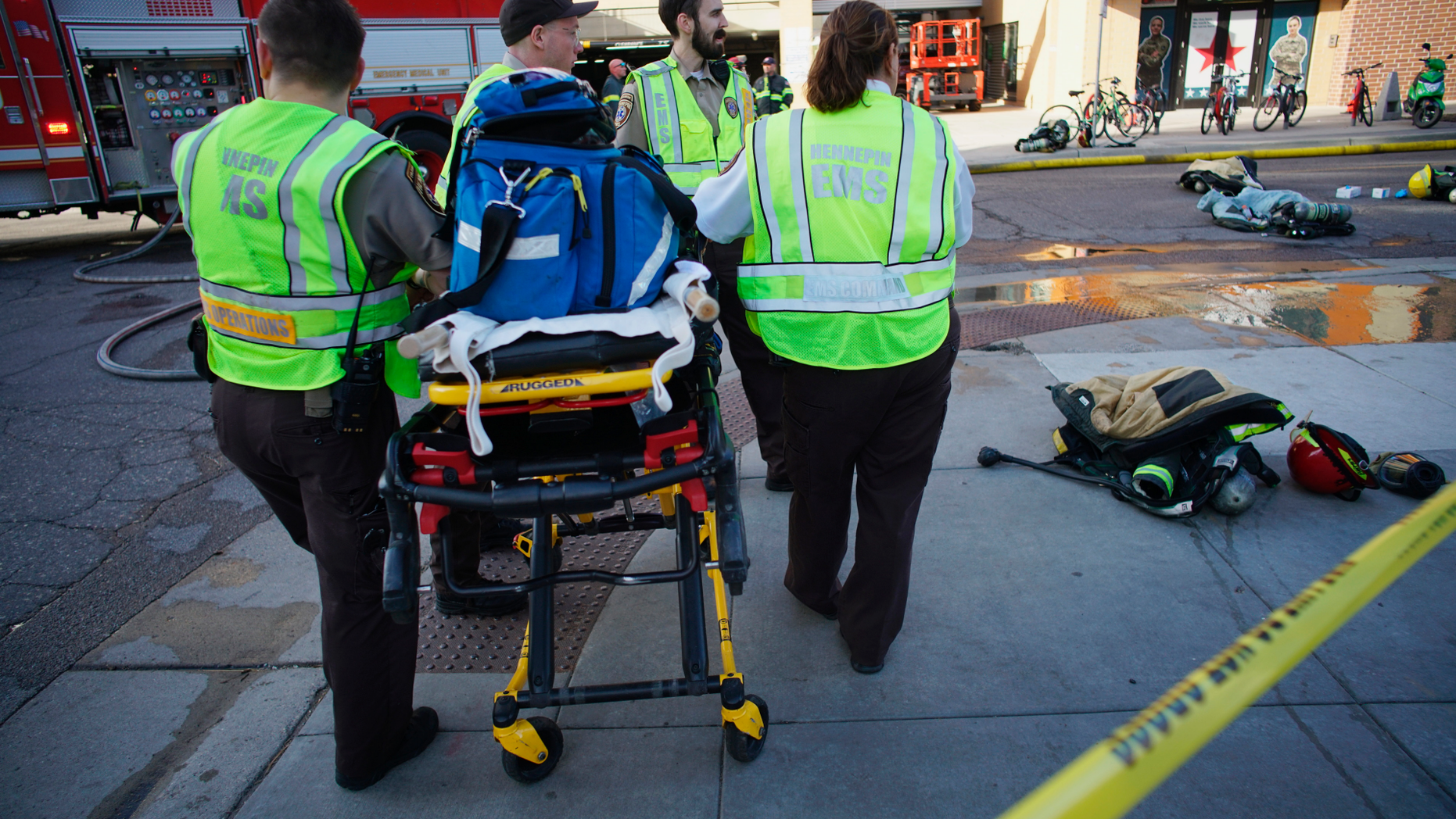Members of an EMT team stand by as a Dinkytown apartment building was being evacuated after a report of a hazardous materials incident in Minneapolis on Tuesday, May 7, 2019. Fire crews are evacuating the residential building near the University of Minnesota because of a suspected hazardous materials incident. (Richard Tsong-Taatarii/Star Tribune via AP)