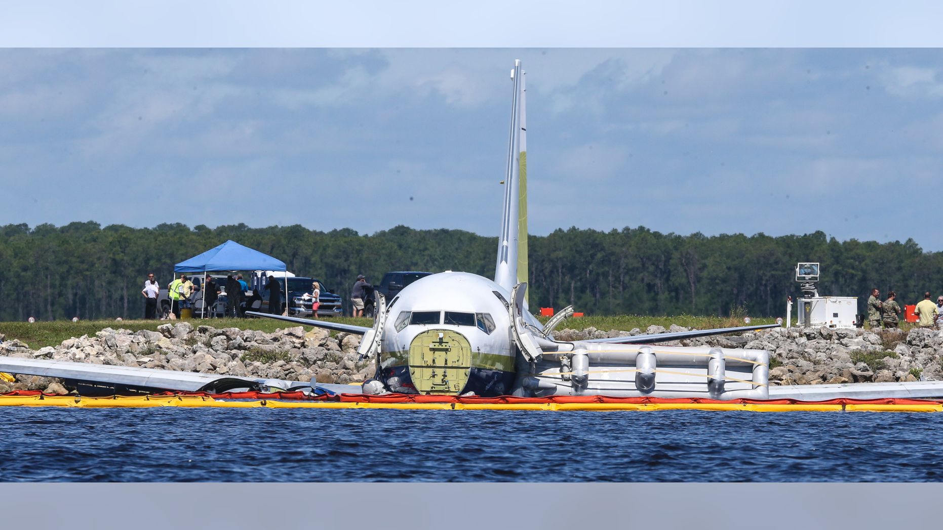 A charter plane carrying 143 people and traveling from Cuba to north Florida sits in a river at the end of a runway, Saturday, May 4, 2019 in Jacksonville, Fla. The Boeing 737 arriving at Naval Air Station Jacksonville from Naval Station Guantanamo Bay, Cuba, with 136 passengers and seven aircrew slid off the runway Friday night into the St. Johns River, a NAS Jacksonville news release said. (AP Photo/Gary McCullough)