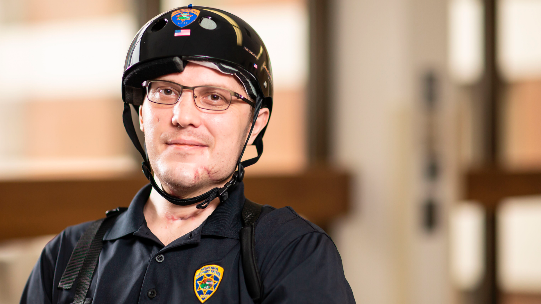 In this image provided by University of Utah Health, Montana Highway Patrol Trooper Wade Palmer poses at University of Utah Health, Wednesday, May 22, 2019, in Salt Lake City. Palmer returned home to Montana on Wednesday to continue his recovery, just over two months after he was shot in the head, face and neck while investigating a fatal shooting. Doctors said Wade Palmer suffered a traumatic brain injury and is unable to speak but seems to understand what is being said. (University of Utah Health via AP)