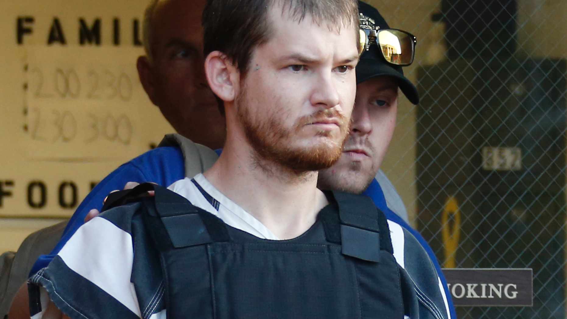 FILE - In this Sept. 11, 2014 file photo, Timothy Ray Jones Jr., is escorted by lawmen out of the Smith County Jail in Raleigh, Miss. A jury has been selected and opening statement should begin soon in the death penalty trial of Jones, a South Carolina father charged with killing his five children. The 12-member jury with six alternates was selected Monday, May 13, 2019 at the Lexington County Courthouse. Opening statements are expected Tuesday afternoon. (AP Photo/Rogelio V. Solis, File)