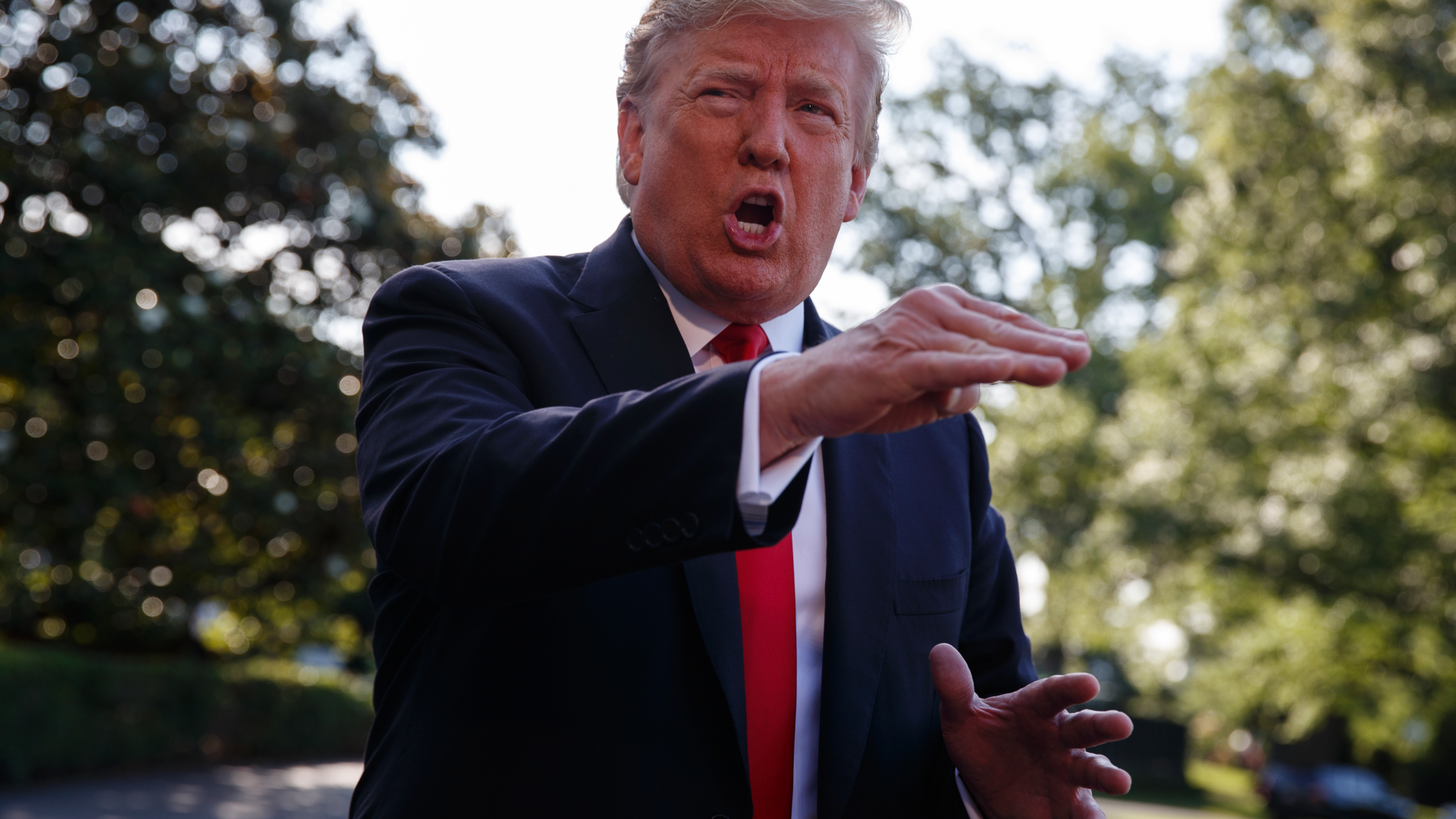 President Donald Trump talks with reporters before departing on Marine One for the Air Force Academy graduation ceremony, Thursday, May 30, 2019, in Washington. (AP Photo/Evan Vucci)