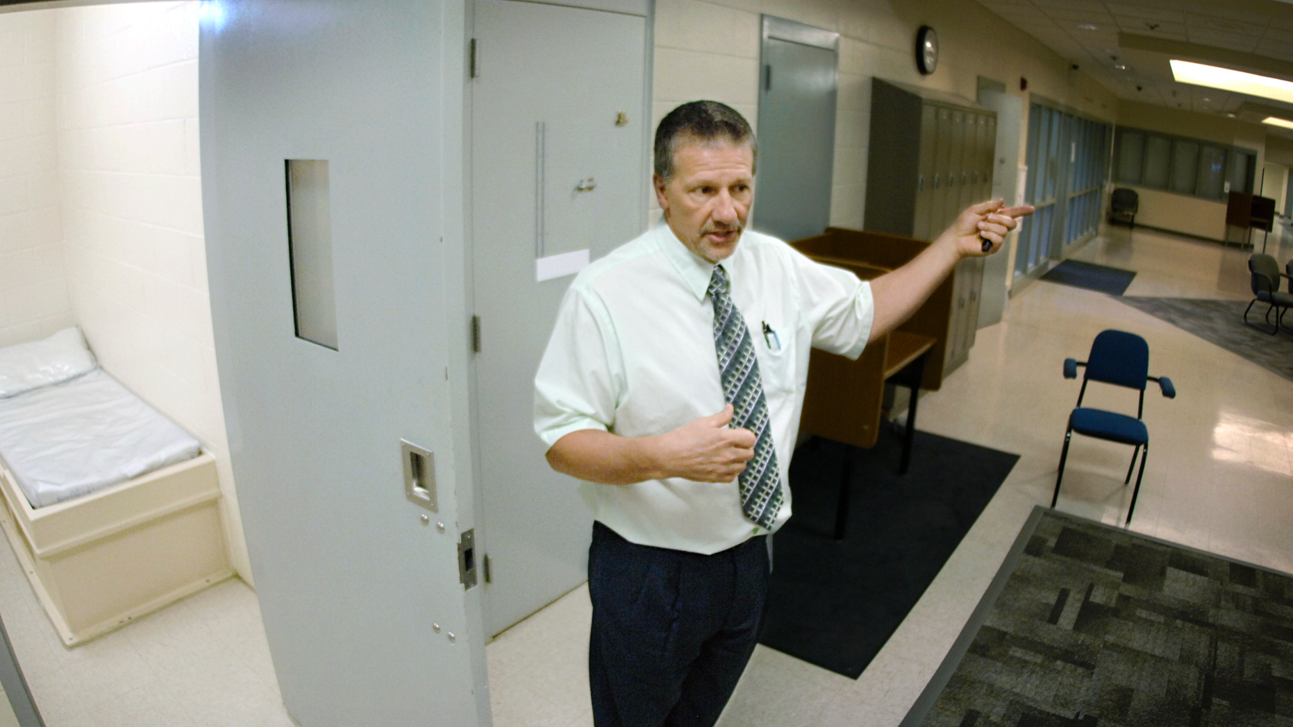 In this May 2018 photo, Tim Tausend, director of the North Dakota Youth Correctional Center, shows a look inside one of the dorm rooms inside the 25-bed Pine Cottage for high-risk male juveniles in Mandan, N.D. Authorities have charged four teenagers, including one from South Dakota, with multiple felonies in adult court in what they described as a riot earlier this year at North Dakota's youth prison. (Mike McCleary/The Bismarck Tribune via AP)