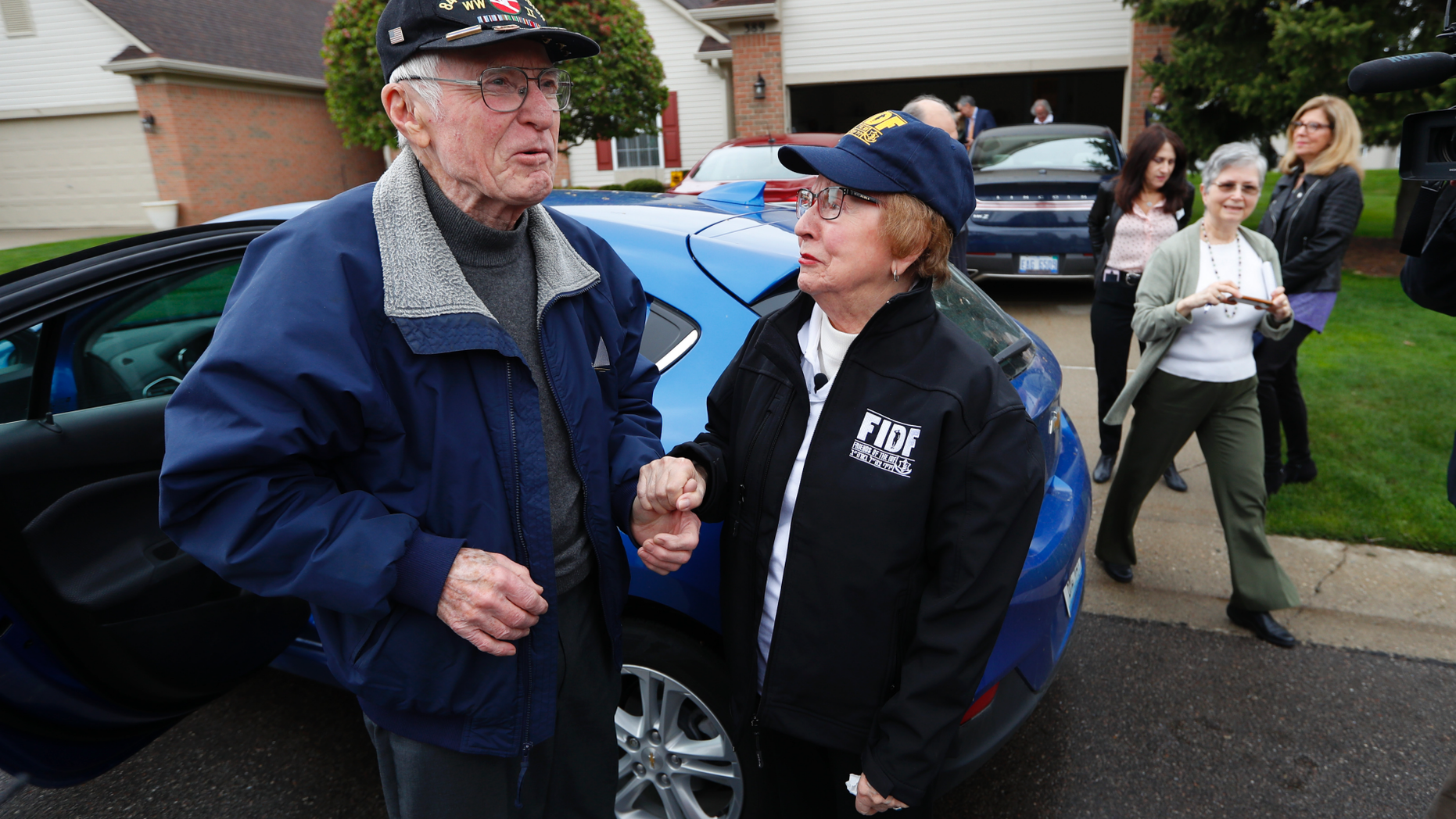Doug Harvey, 95, and holocaust survivor Sophie Tajch Klisman, 89, right, greet each other in Commerce Township, Mich., Monday, May 13, 2019. Harvey, was a US Army soldier in the 84th Infantry Division, which helped liberate the Salzwedel concentration camp in Nazi Germany and free its captives including Klisman. (AP Photo/Paul Sancya)