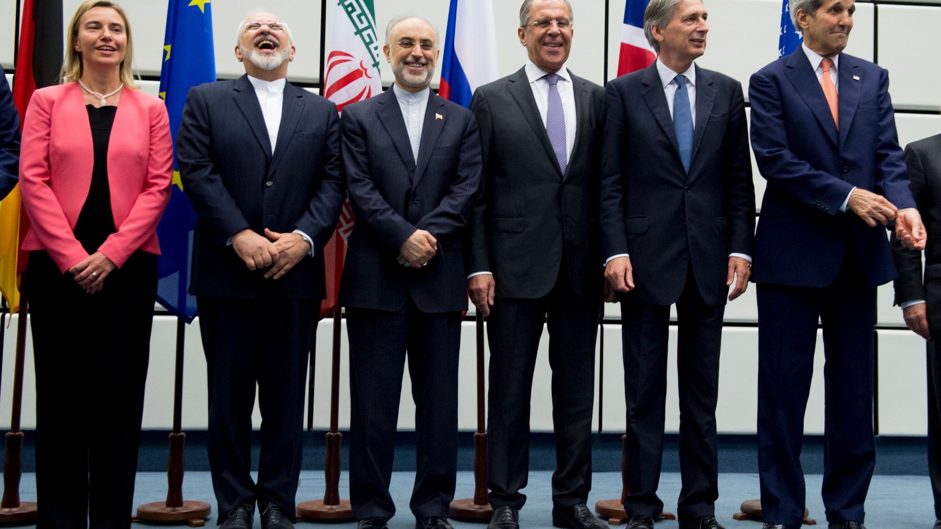 FILE - In this July 14, 2015 file photo, from left to right: European Union High Representative Federica Mogherini, Iranian Foreign Minister Mohammad Javad Zarif, Head of the Iranian Atomic Energy Organization Ali Akbar Salehi, Russian Foreign Minister Sergey Lavrov, British Foreign Secretary Philip Hammond and U.S. Secretary of State John Kerry pose for a group picture at the United Nations building in Vienna, Austria. Iran threatened Wednesday, May 8, 2019, to resume higher enrichment of uranium in 60 days if world powers fail to negotiate new terms for its 2015 nuclear deal, an agreement that capped over a decade of hostility between Tehran and the West over its atomic program. (Joe Klamar/Pool Photo via AP, File)