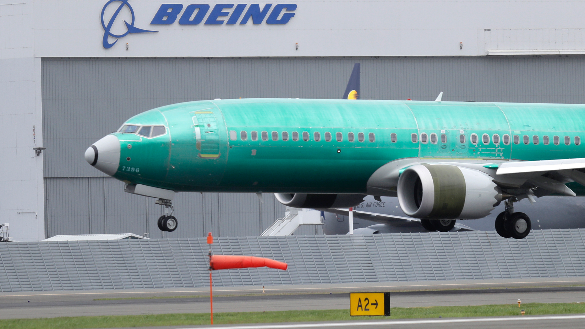FILE - In this April 10, 2019, file photo a Boeing 737 MAX 8 airplane being built for India-based Jet Airways lands following a test flight at Boeing Field in Seattle. The grounding of Boeing 737 Max jets likely means that fare increases this summer will be larger than already expected and airlines will struggle to handle disruptions such as storms that shut down hub airports. (AP Photo/Ted S. Warren, File)