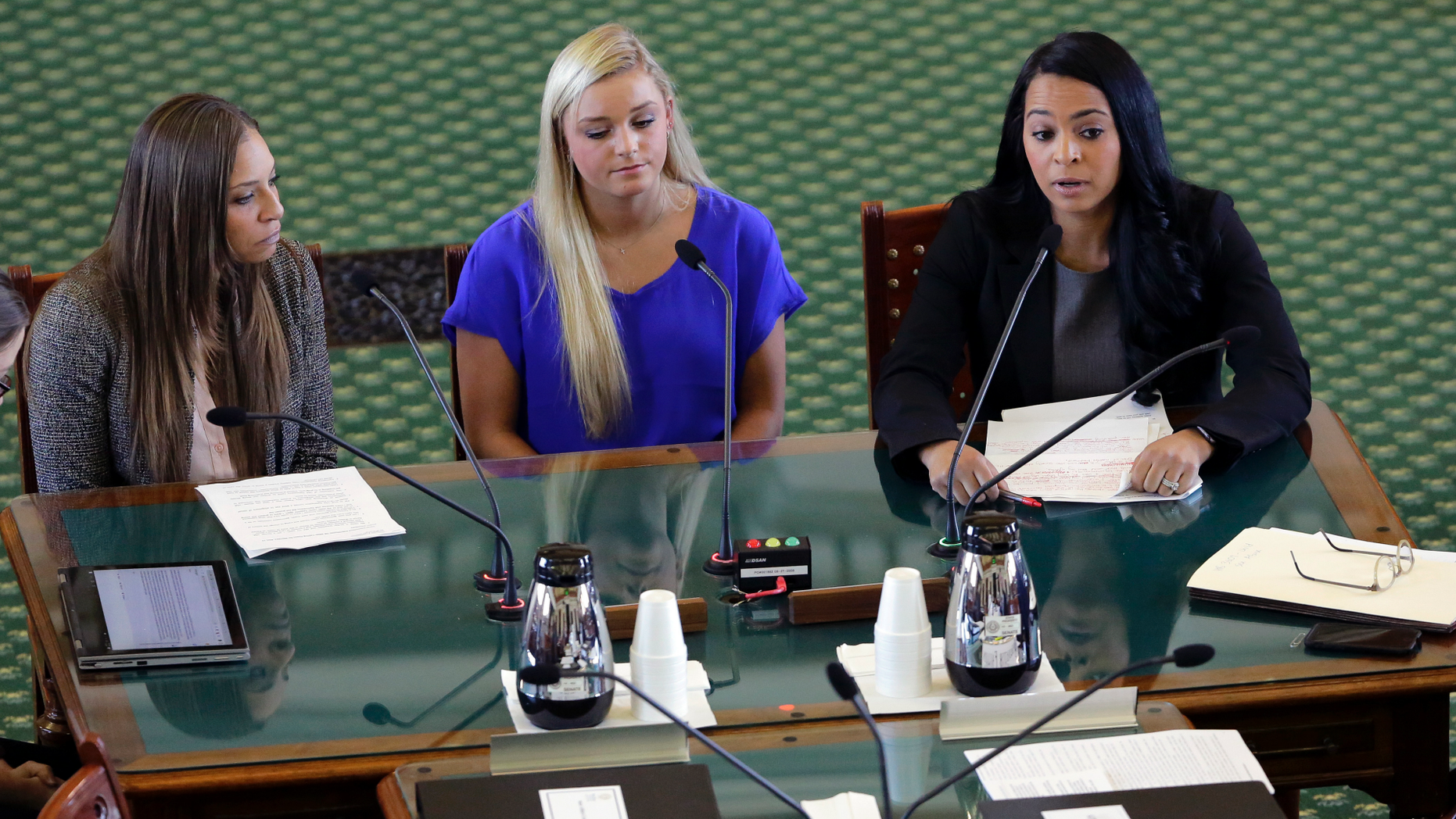 Former gymnasts Jordan Schwikert, left, Amy Baumann, center, and Tasha Schwikert, right, take part in a hearing about the statute of limitations child sex abuse victims have to sue their abusers, Monday, May 13, 2019, in Austin, Texas. In Texas, lawmakers quietly removed a bill's provision allowing child sex abuse victims to sue institutions and are now shielding the very groups that lobbied them to do so. (AP Photo/Eric Gay)
