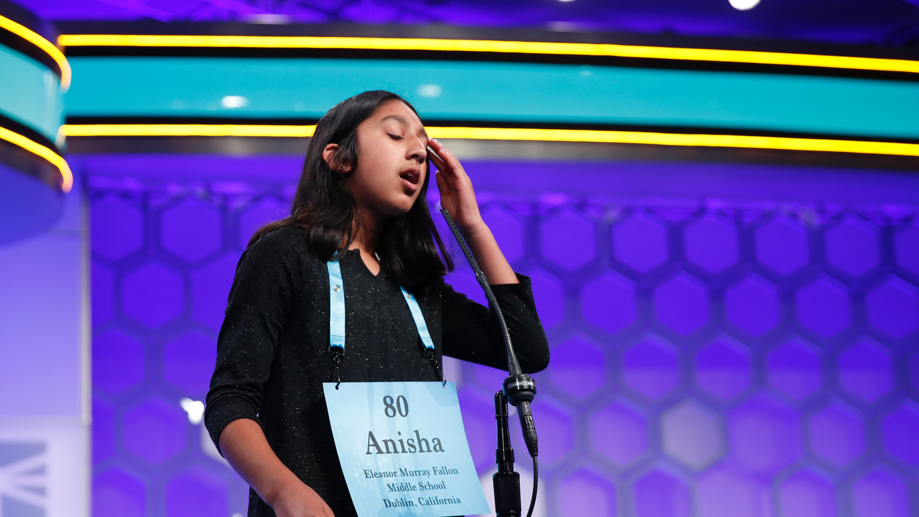 FILE - In this May 31, 2018 file photo, Anisha Rao, 12, from Dublin, Calif., reacts after spelling a word incorrectly during the evening finals of the Scripps National Spelling Bee in Oxon Hill, Md. An unremarkable sound can be the toughest thing for spellers to master at the Scripps National Spelling Bee. It's known as the schwa. It sounds like "Uh," and any vowel can make the sound. Spellers have a variety of techniques to figure out unfamiliar schwas, but none of the strategies is foolproof, and sometimes the only things to do are to memorize the word or guess. (AP Photo/Carolyn Kaster)