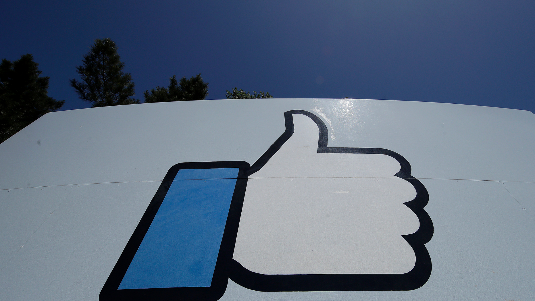This April 25, 2019, photo shows the thumbs up Like logo on a sign at Facebook headquarters in Menlo Park, Calif. (AP Photo/Jeff Chiu)