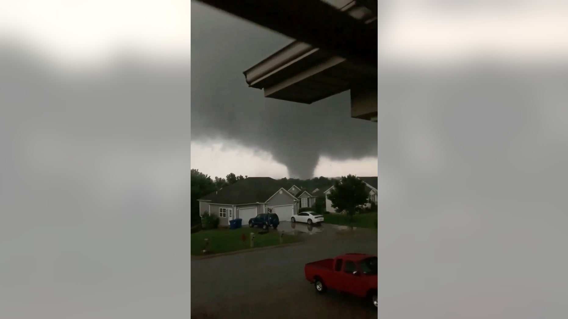 This still image taken from video provided by Chris Higgins shows a tornado, Wednesday, May 22, 2019, in Carl Junction, Mo. The tornado caused some damage in the town of Carl Junction, about 4 miles (6.44 kilometers) north of the Joplin airport. (Chris Higgins via AP)