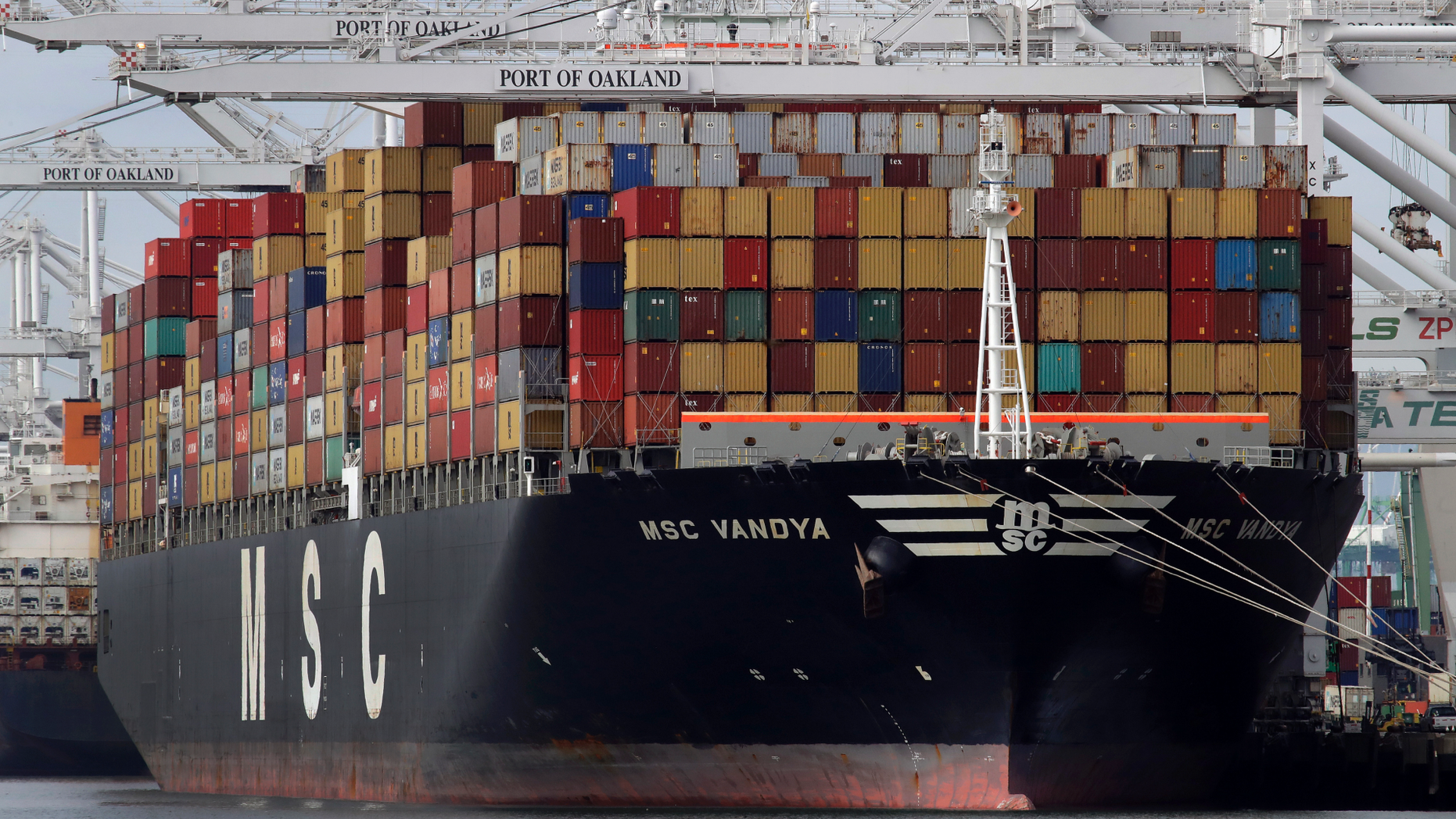 FILE- In this Jan. 28, 2019, file photo a container ship is unloaded at the Port of Oakland in Oakland, Calif. On Thursday, May 2, the Labor Department issues revised data on productivity in the first quarter. (AP Photo/Ben Margot, File)