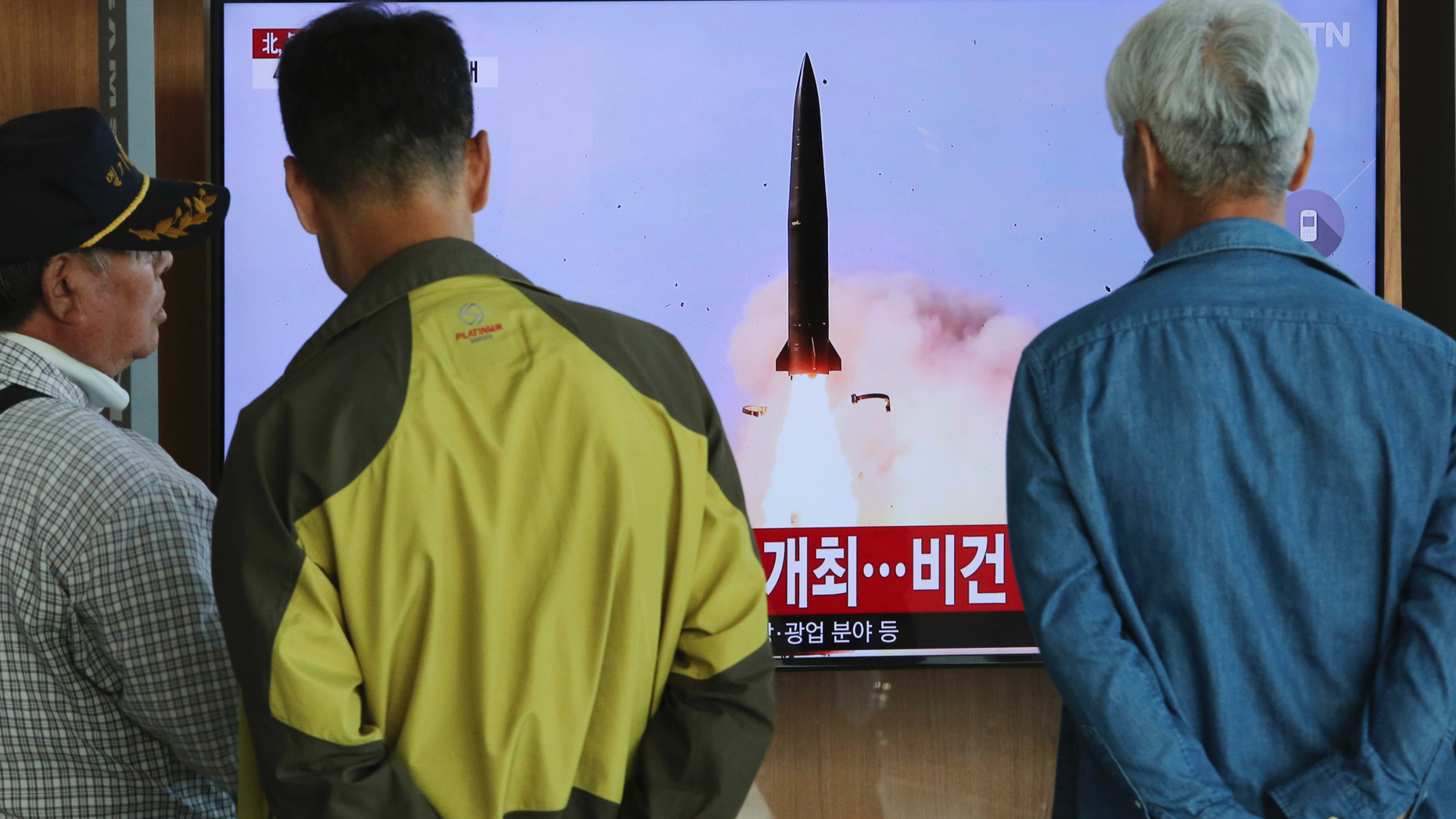 People watch a TV showing a file photo of North Korea's weapon systems during a news program at the Seoul Railway Station in Seoul, South Korea, Thursday, May 9, 2019. North Korea on Thursday fired at least one unidentified projectile from the country's western area, South Korea's military said, the second such launch in the last five days and a possible warning that nuclear disarmament talks could be in danger. (AP Photo/Ahn Young-joon)