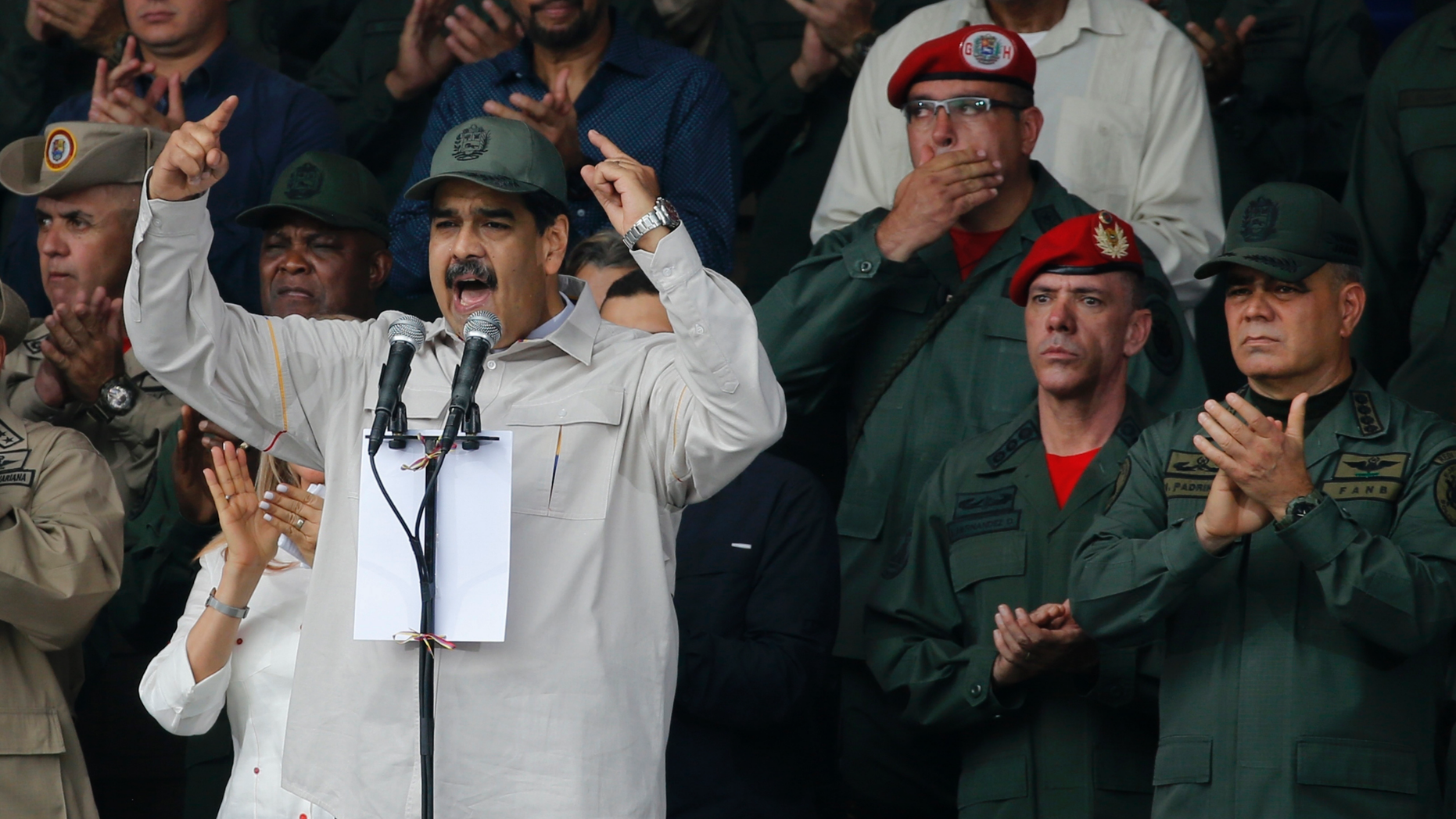 FILE - In this April 13, 2019 file photo, Venezuela's President Nicolas Maduro, speaks flanked by Defense Minister Vladimir Padrino Lopez, right, and Gen. Ivan Hernandez, second from right, head of both the presidential guard and military counterintelligence in Caracas, Venezuela. The Associated Press has learned that at least twice since 2016, the U.S. government missed chances to cultivate relations with regime insiders, including Padrino and Hernández, who National Security Adviser John Bolton said backed out of a plan to topple Maduro. (AP Photo/Ariana Cubillos, File)