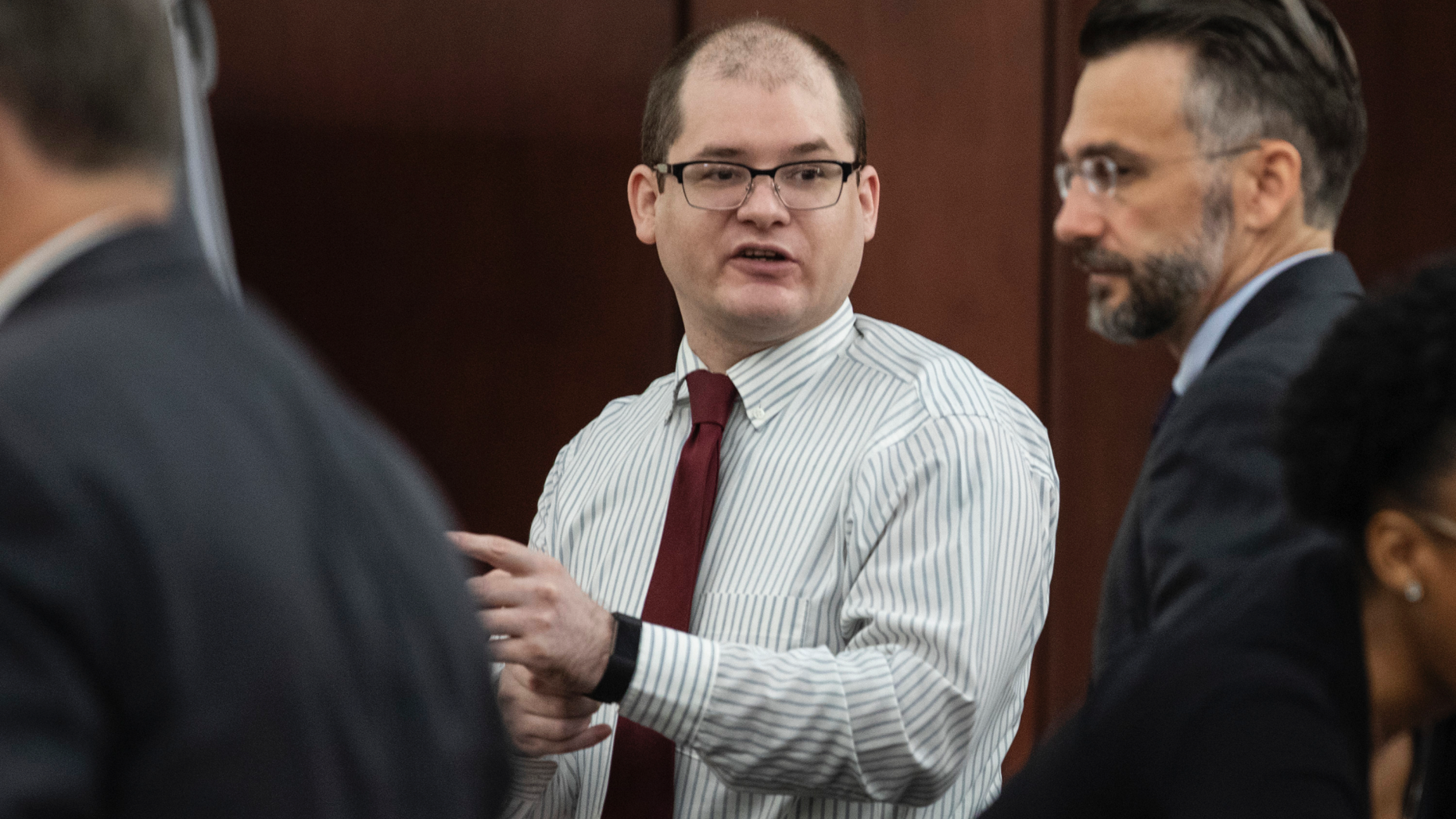 Timothy Jones Jr., center, charged with killing his five children, speaks with his attorneys, Boyd Young, left, and Casey Secor during his trial in Lexington, S.C., Wednesday, May 22, 2019. Lawyers defending Jones turned Wednesday to brain science in an effort to spare their client from the death penalty. (Tracy Glantz/The State via AP, Pool)
