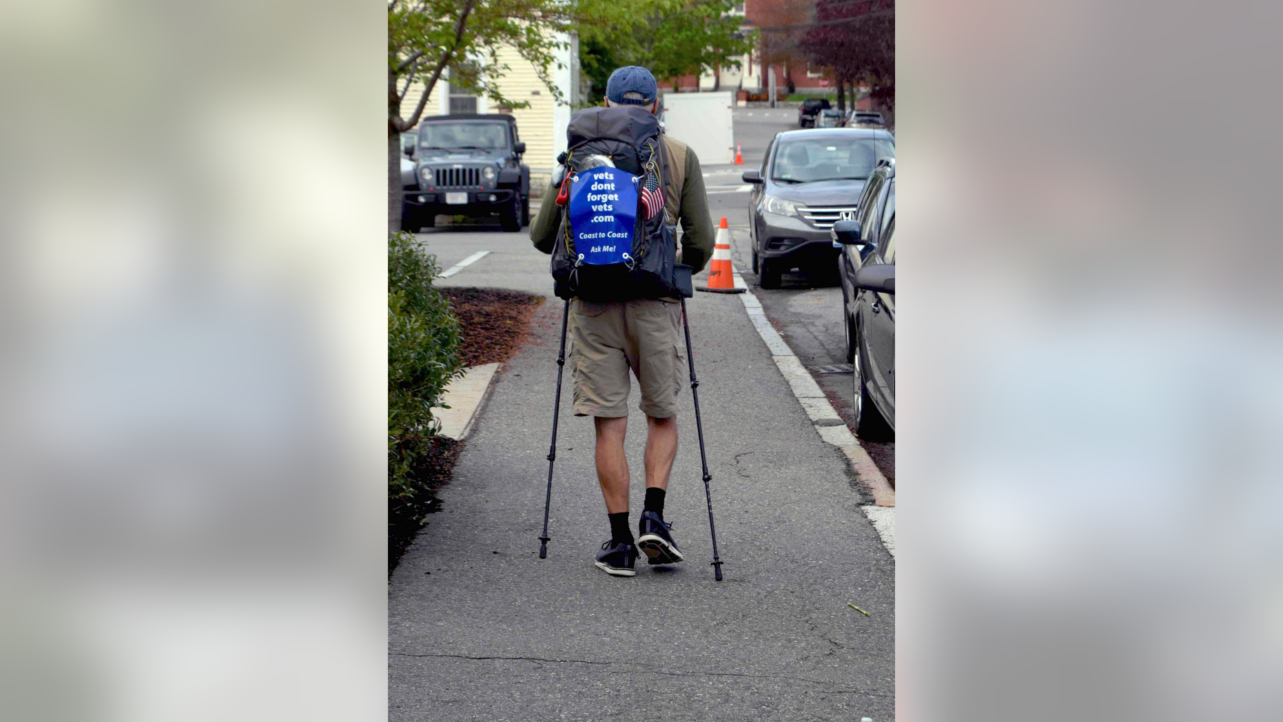 In this Wednesday, May 15, 2019 photo, U.S. Air Force veteran William Shuttlesworth walks up Market Street, in Newburyport, Mass., at the start of his planned cross-country hike to raise awareness for veterans' issues. Shuttleworth, 71, trained for several months carrying his full backpack while walking several miles each day. (Richard K. Lodge/The Daily News of Newburyport via AP)