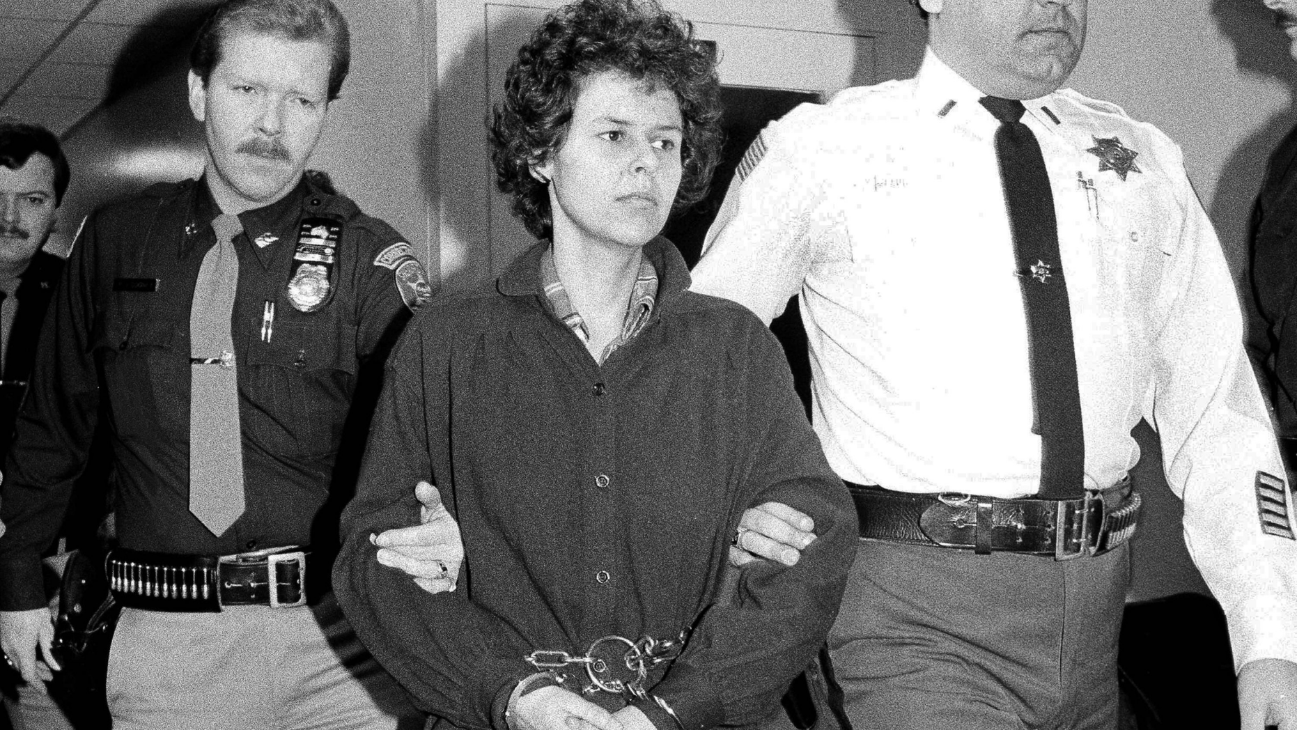 FILE - In this Nov. 24, 1981, file photo, Weather Underground member Judith Clark is handcuffed as she is escorted into Rockland County Courthouse in New City, N.Y. State prison officials say Clark was released Friday, May 10, 2019, from Bedford Hills Correctional Facility in Westchester County. She became eligible for parole consideration after Gov. Andrew Cuomo granted her clemency in 2016, citing her many achievements in prison. (AP Photo/David Handschuh, File)
