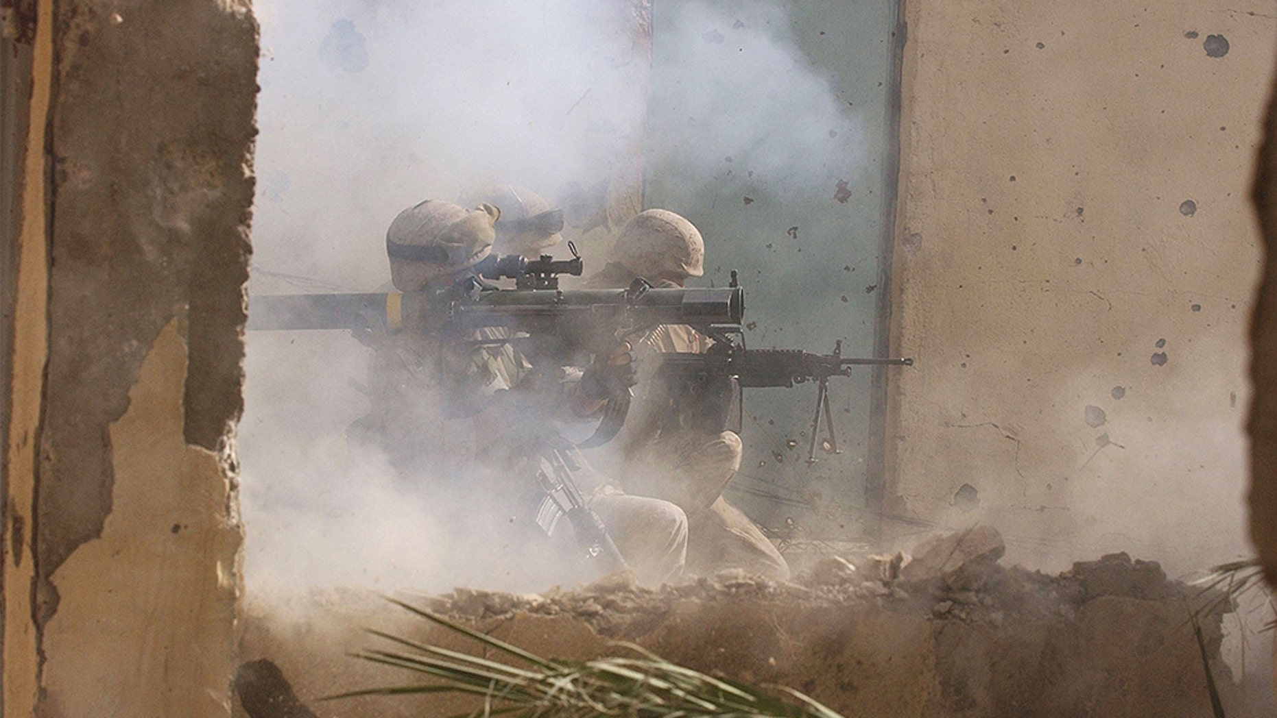 FILE -- NOVEMBER 23, 2004: U.S. Marines of the Light Armored Reconnaissance (LAR) company of 1st Battalion 3rd Marines, fire a rocket to clear houses at the site where four insurgents staged a bloody counter-attack, killing one American and wounding many others in Fallujah, Iraq.  (Photo by Scott Peterson/Getty Images)