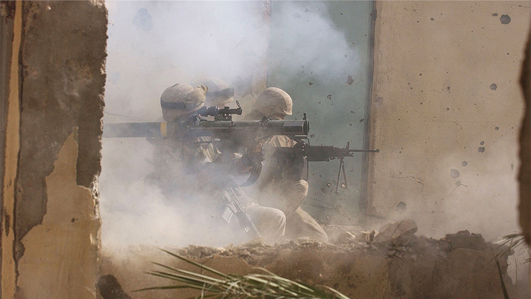 FILE -- NOVEMBER 23, 2004: U.S. Marines of the Light Armored Reconnaissance (LAR) company of 1st Battalion 3rd Marines, fire a rocket to clear houses at the site where four insurgents staged a bloody counter-attack, killing one American and wounding many others in Fallujah, Iraq. (Photo by Scott Peterson/Getty Images)