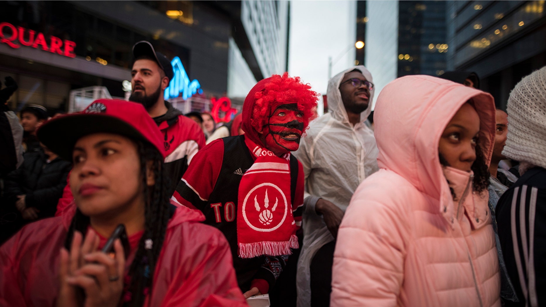 Toronto Raptors basketball fans react to game action at the Jungle Park tailgate party at Maple Leaf Square during the first half of an NBA Eastern Conference semifinal in Toronto. For Raptors games, Maple Leaf Square, aka Jurassic Park, boasts a college vibe of rowdy fans crammed into an area that covers two city blocks. (Tijana Martin/The Canadian Press via AP, File)
