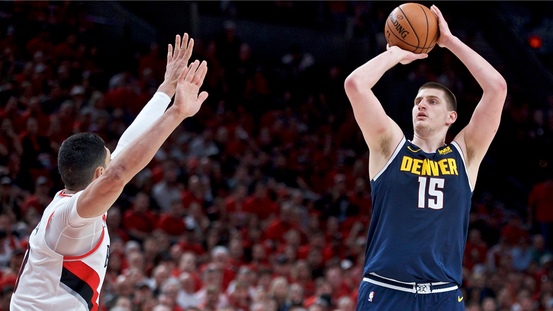 Denver Nuggets center Nikola Jokic, right, looks to shoot over Portland Trail Blazers center Enes Kanter during the first half of Game 4 of an NBA basketball second-round playoff series Sunday, May 5, 2019, in Portland, Ore. (AP Photo/Craig Mitchelldyer)